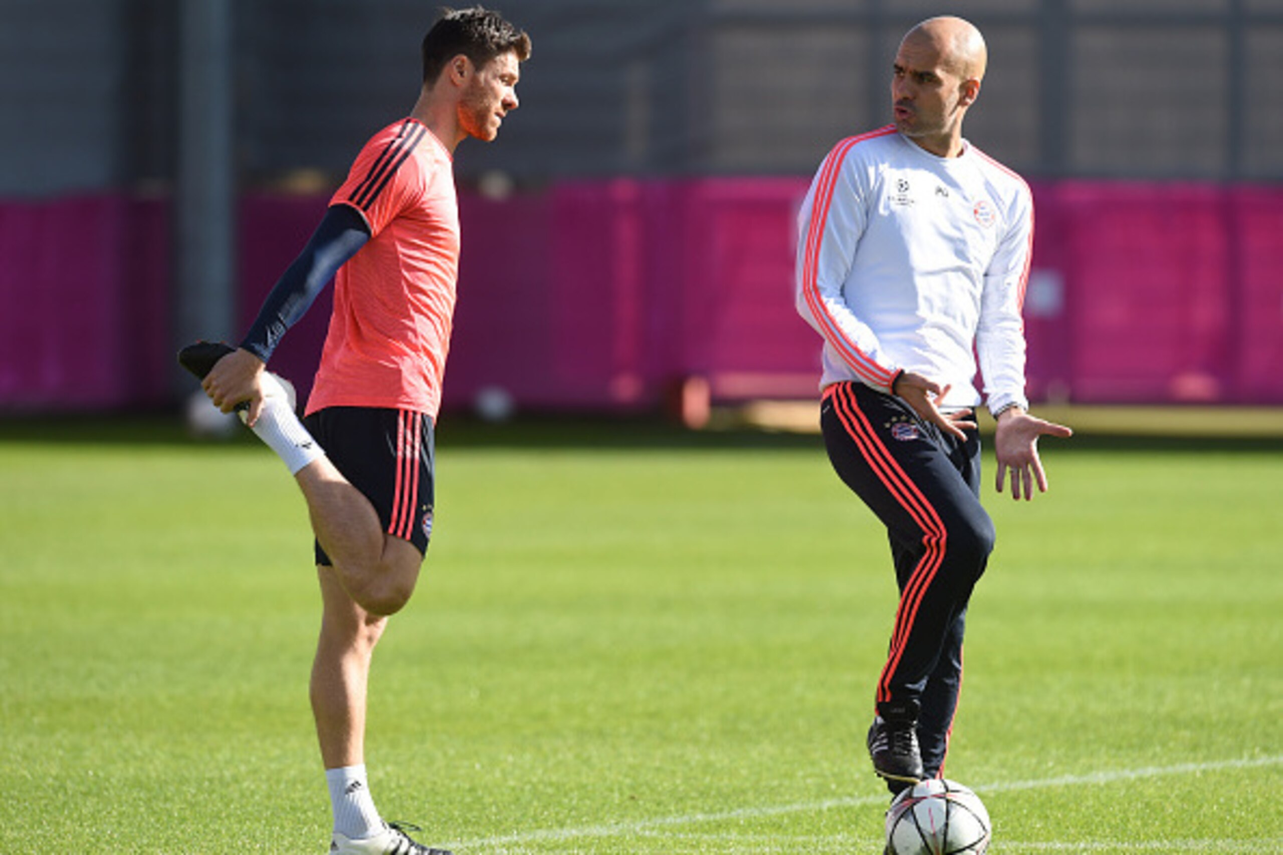 Bayern Munich's Spanish head coach Pep Guardiola (R) talks with Bayern Munich's Spanish midfielder Xabi Alonso (L) during the last team trainings session one day before the Champions League last 16, first-leg match between Juventus Turin and Bayern Munich Bayern Munich's Spanish head coach Pep Guardiola (R) talks with Bayern Munich's Spanish midfielder Xabi Alonso (L) during the last team trainings session one day before the Champions League last 16, first-leg match between Juventus Turin and Bayern Munich
