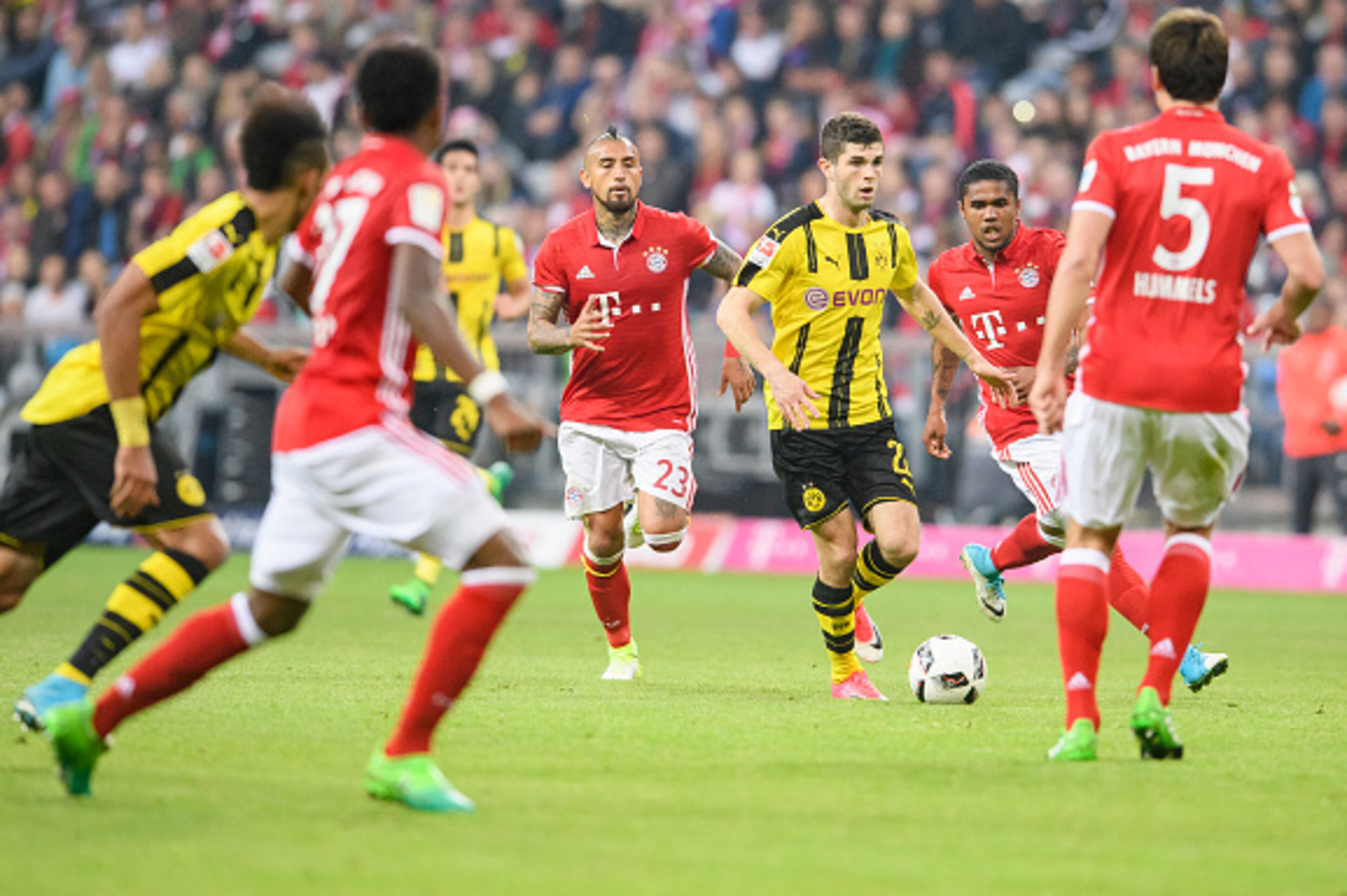 MUNICH, GERMANY - APRIL 08: Christian Pulisic of Dortmund in action against Douglas Costa of Bayern Muenchen (R) during the Bundesliga match between Bayern Muenchen and Borussia Dortmund at Allianz Arena on April 8, 2017 in Munich, Germany. (Photo by Alex