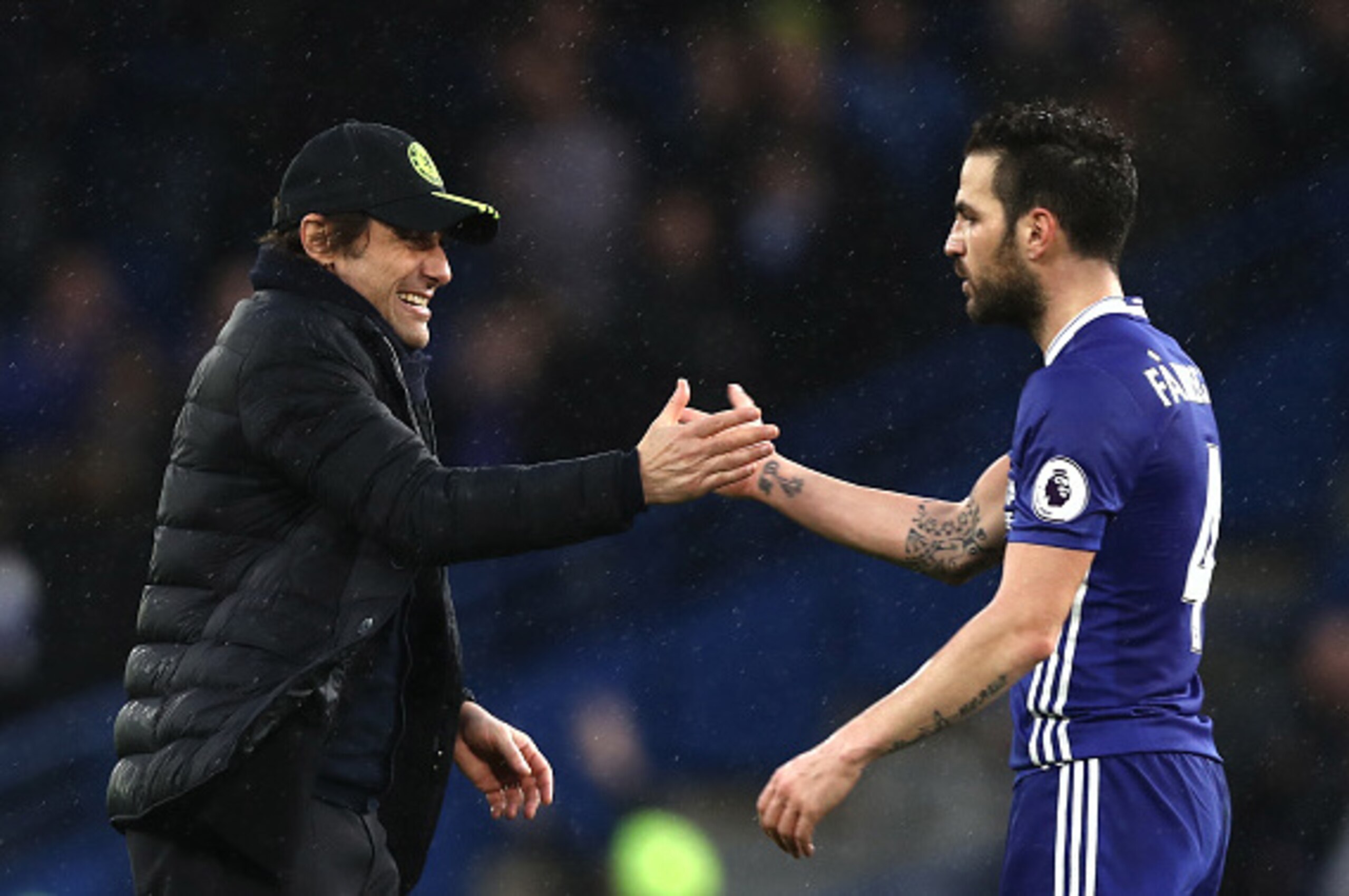LONDON, ENGLAND - FEBRUARY 25:  Antonio Conte, Manager of Chelsea (L) and Cesc Fabregas of Chelsea (R) embrace after the Premier League match between Chelsea and Swansea City at Stamford Bridge on February 25, 2017 in London, England.  (Photo by Clive Ros