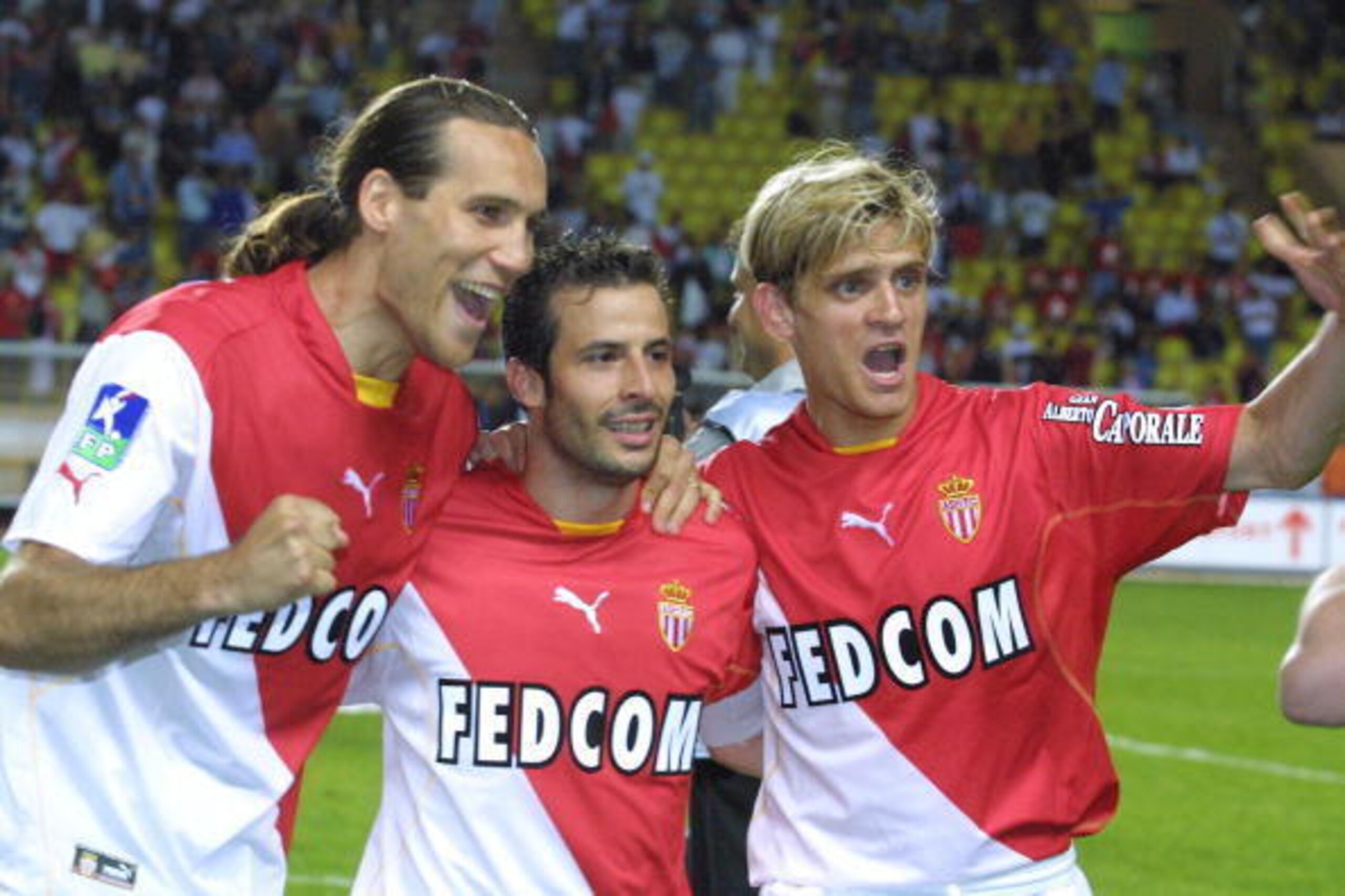 Monaco's midfielder Jerome Rothen (R), forward Dado Prso (L) and captain Ludovic Giuly, jubilate after winning the French L1 soccer match against Troyes, 24 May in Monaco.   AFP PHOTO JACQUES MUNCH  (Photo credit should read JACQUES MUNCH/AFP/Getty Images