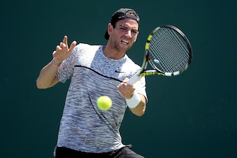 KEY BISCAYNE, FL - MARCH 27:  Adrian Mannarino of France returns a shot to Borna Coric of Croatia during the Miami Open at the Crandon Park Tennis Center on March 27, 2017 in Key Biscayne, Florida.  (Photo by Matthew Stockman/Getty Images)