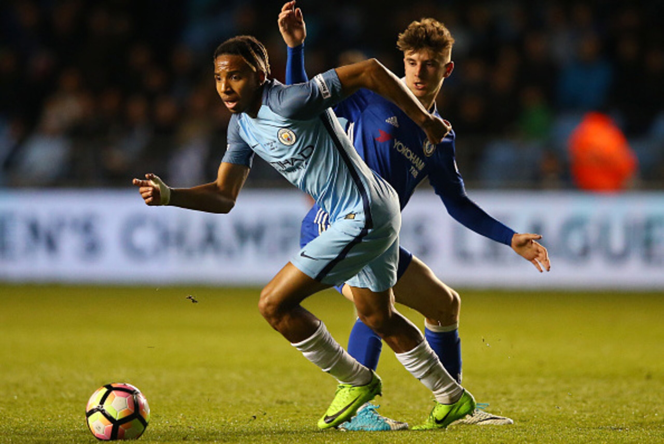 MANCHESTER, ENGLAND - APRIL 18: Demeaco Duhaney of Manchester City takes the ball past Mason Mount of Chelsea during the FA Youth Cup Final First Leg match between Manchester City and Chelsea at The Academy Stadium on April 18, 2017 in Manchester, England