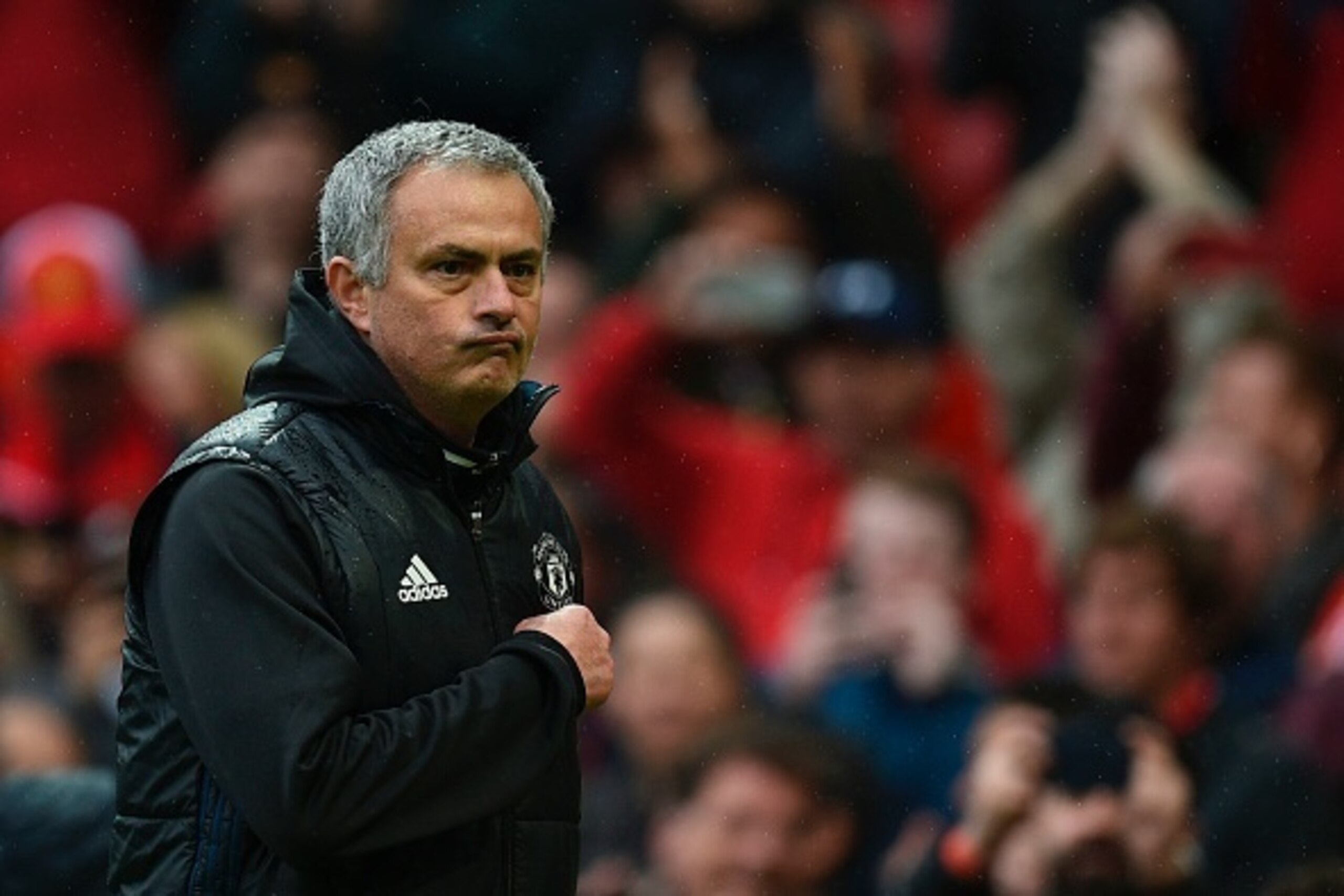 Manchester United's Portuguese manager Jose Mourinho points at the badge on his chest as he leaves the pitch at the end of the English Premier League football match between Manchester United and Chelsea at Old Trafford in Manchester, north west England, o Manchester United's Portuguese manager Jose Mourinho points at the badge on his chest as he leaves the pitch at the end of the English Premier League football match between Manchester United and Chelsea at Old Trafford in Manchester, north west England, o