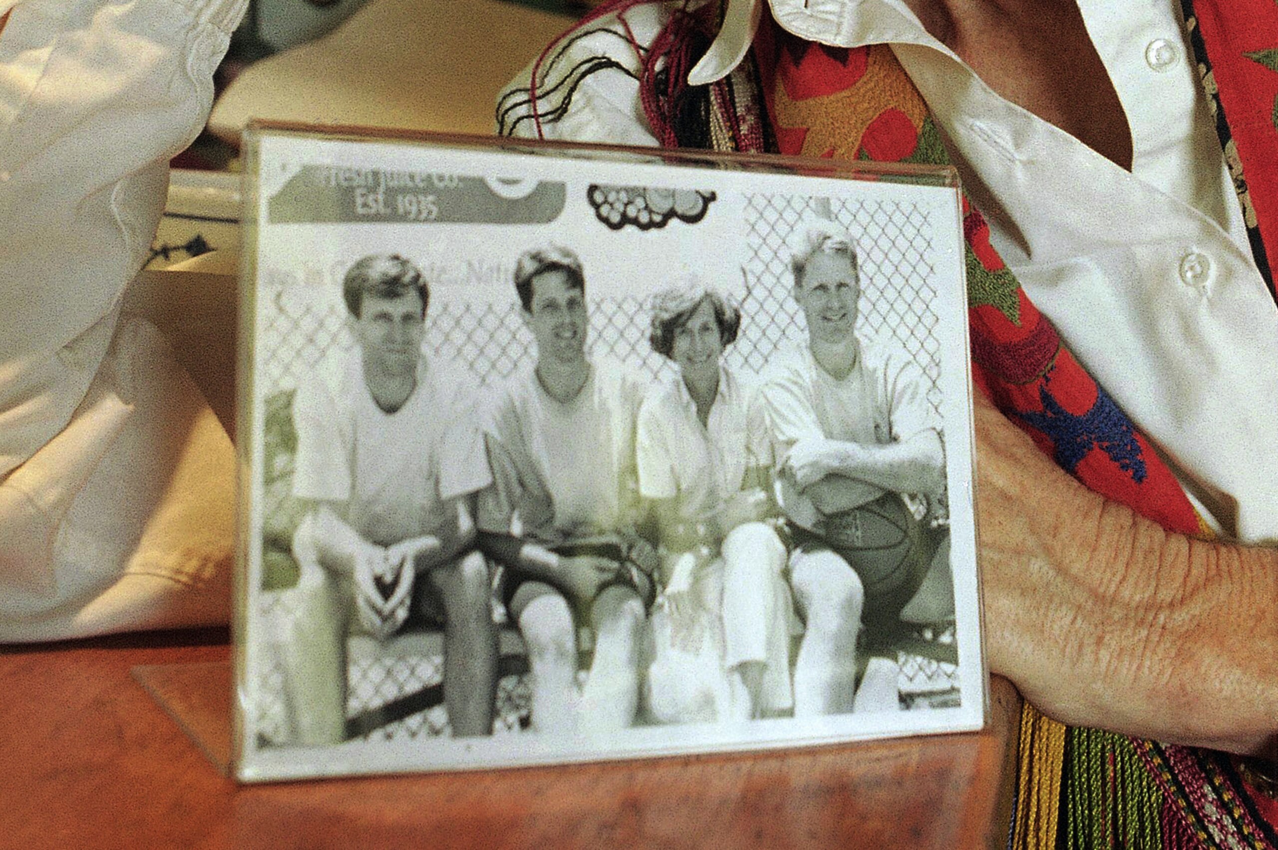 Kerr's mother, Ann, shows a 1995 photo of her with her sons (from left) John, Andrew and Steve.