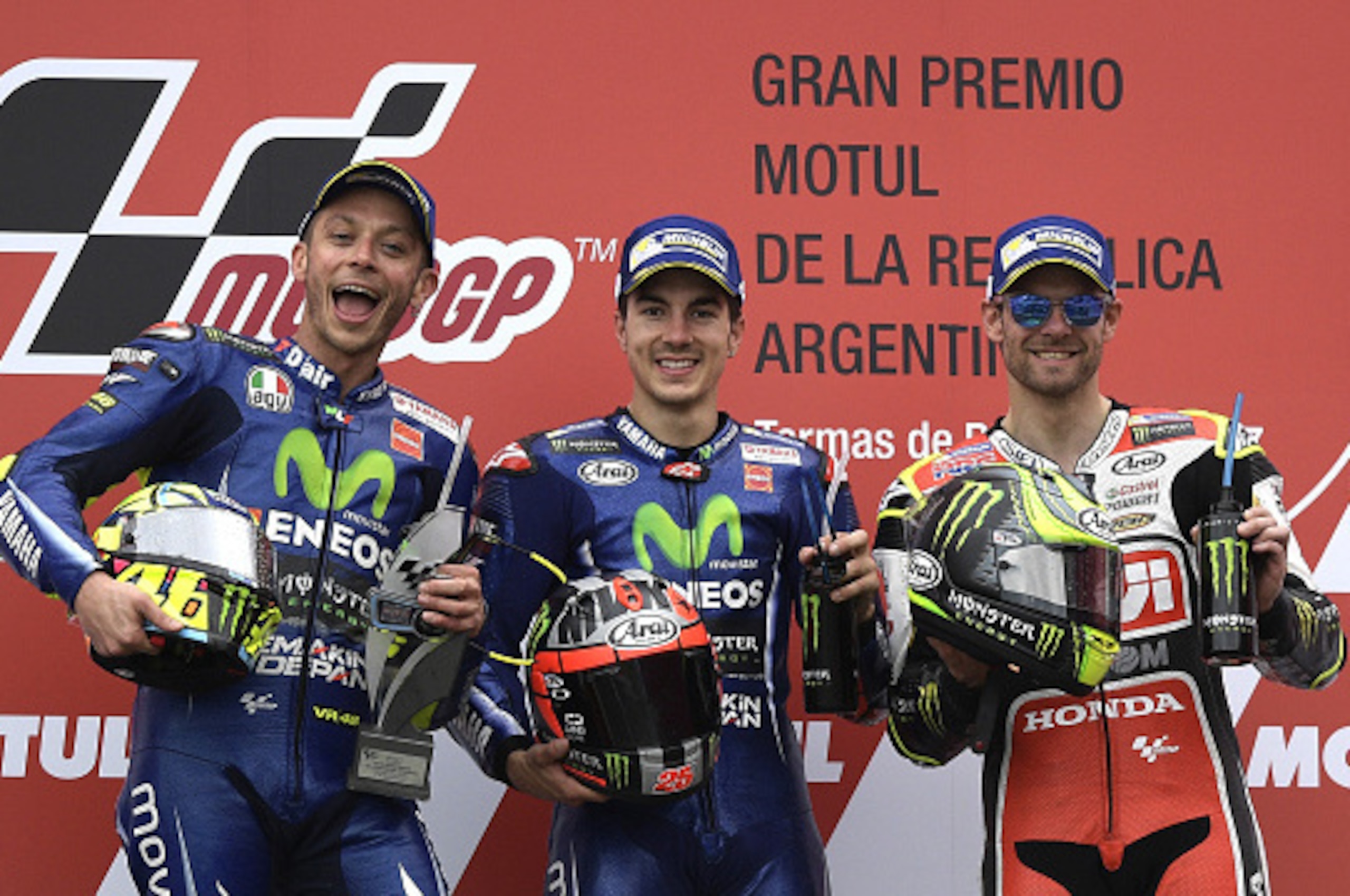 The winner, Yamaha's Spanish biker Maverick Vinales (C), 2nd placed --also from Yamaha--Italian Valentino Rossi (L) and 3rd placed Honda biker Cal Crutchlow from the UK celebrate on the podium of the MotoGP race of the Argentina Grand Prix at Termas de Ri