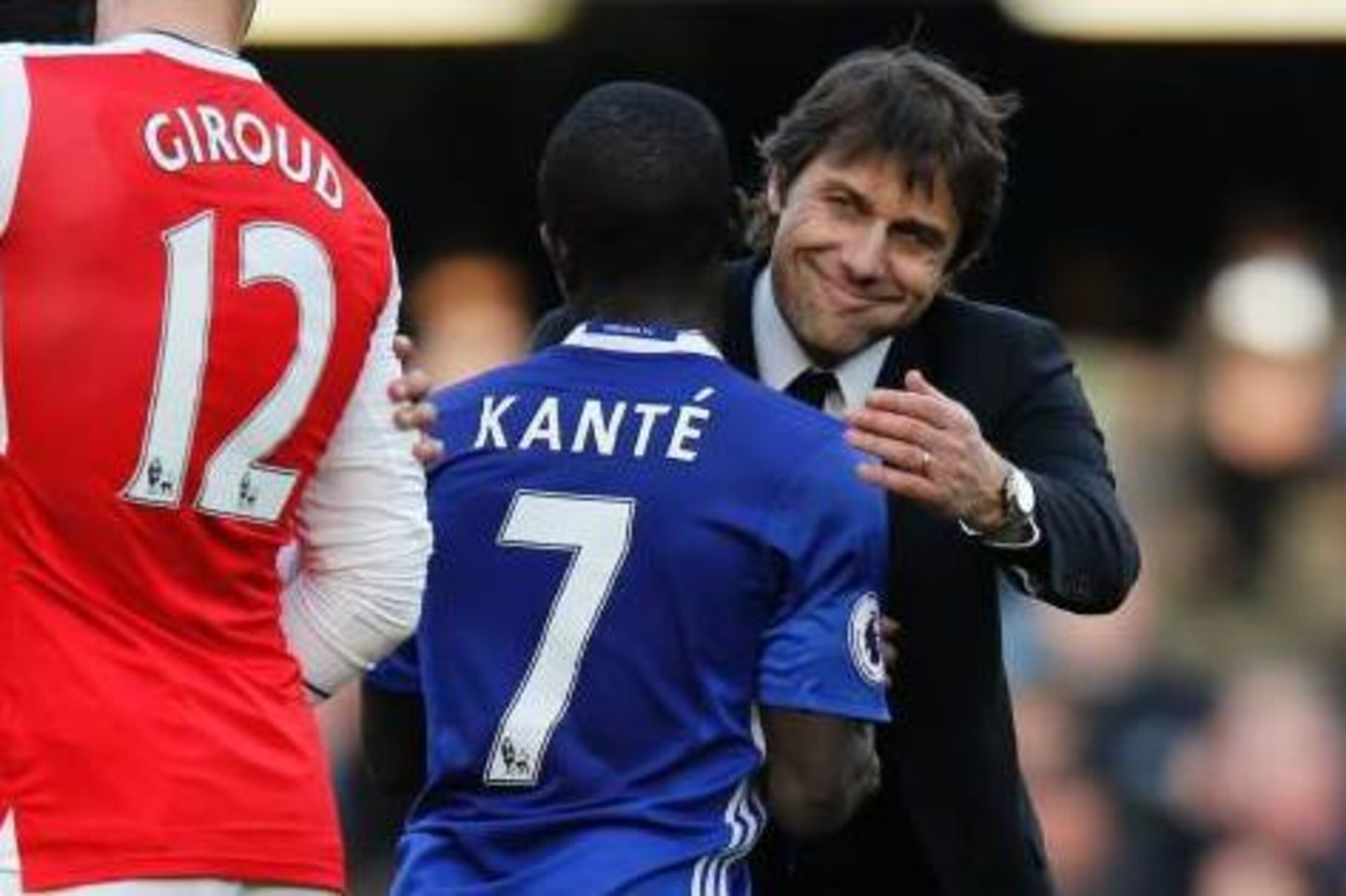 Chelsea's Italian assistant coach Gianluca Conte (R) embraces Chelsea's French midfielder N'Golo Kante (2R) during the English Premier League football match between Chelsea and Arsenal at Stamford Bridge in London on February 4, 2017. / AFP / Ian KINGTON 