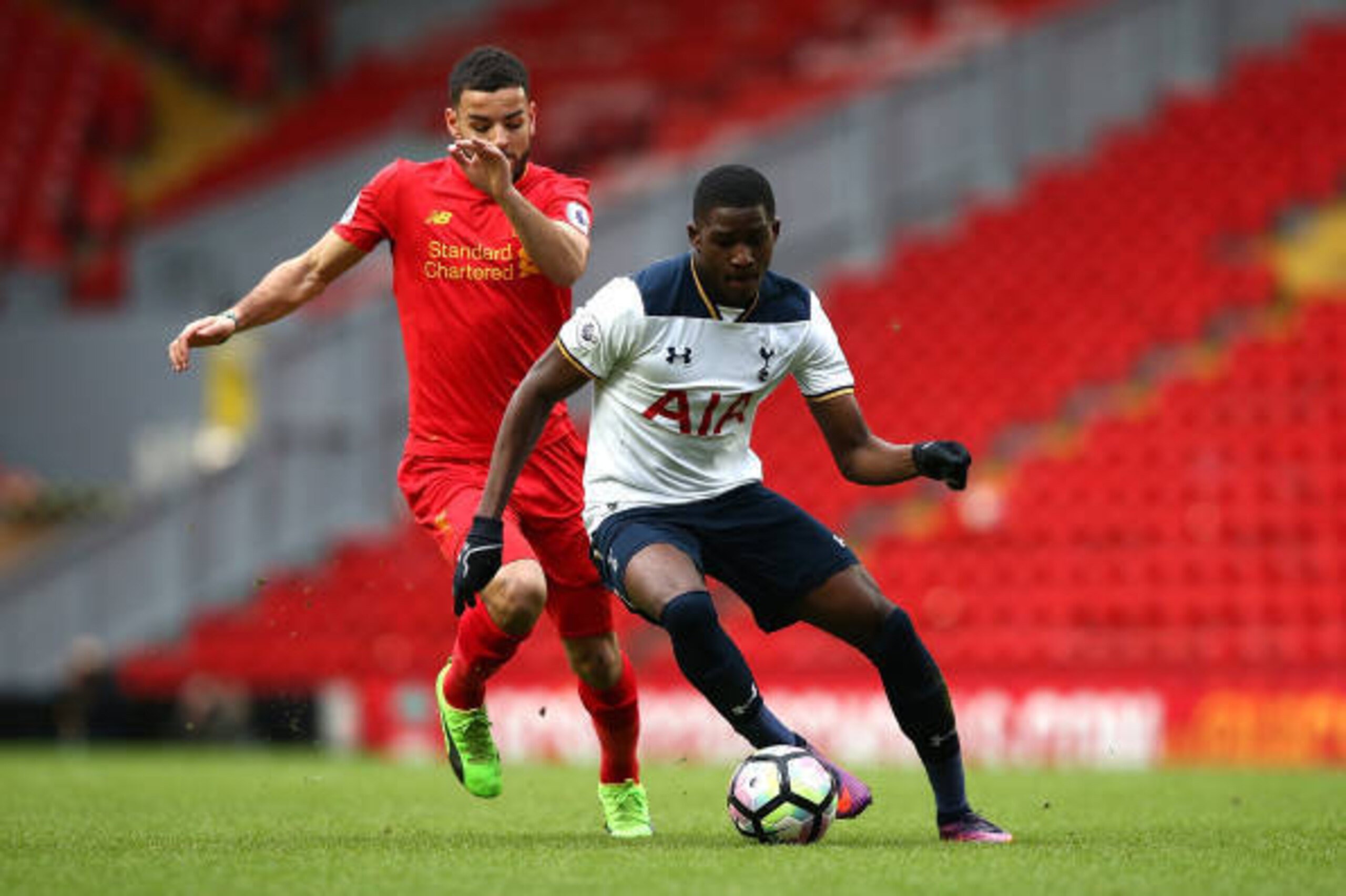 LIVERPOOL, ENGLAND - FEBRUARY 05:  Shilow Tracey of Tottenham Hotspur battles with Kevin Stewart of Liverpool during the Premier League 2 match between Liverpool and Tottenham Hotspur at Anfield on February 5, 2017 in Liverpool, England.  (Photo by Jan Kr