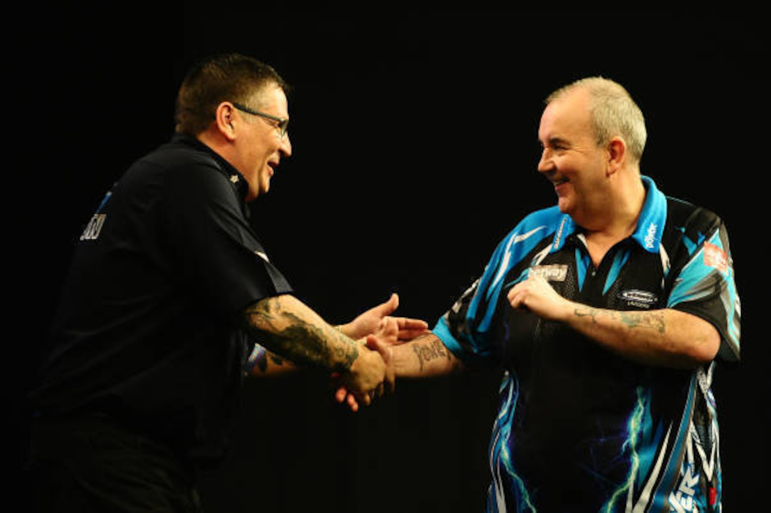 EXETER, UNITED KINGDOM - MARCH 02: Gary Anderson(L) and Phil Taylor embrace during Night Five of the Betway Premier League Darts at Westpoint Arena on March 2, 2017 in Exeter, England. (Photo by Harry Trump/Getty Images)