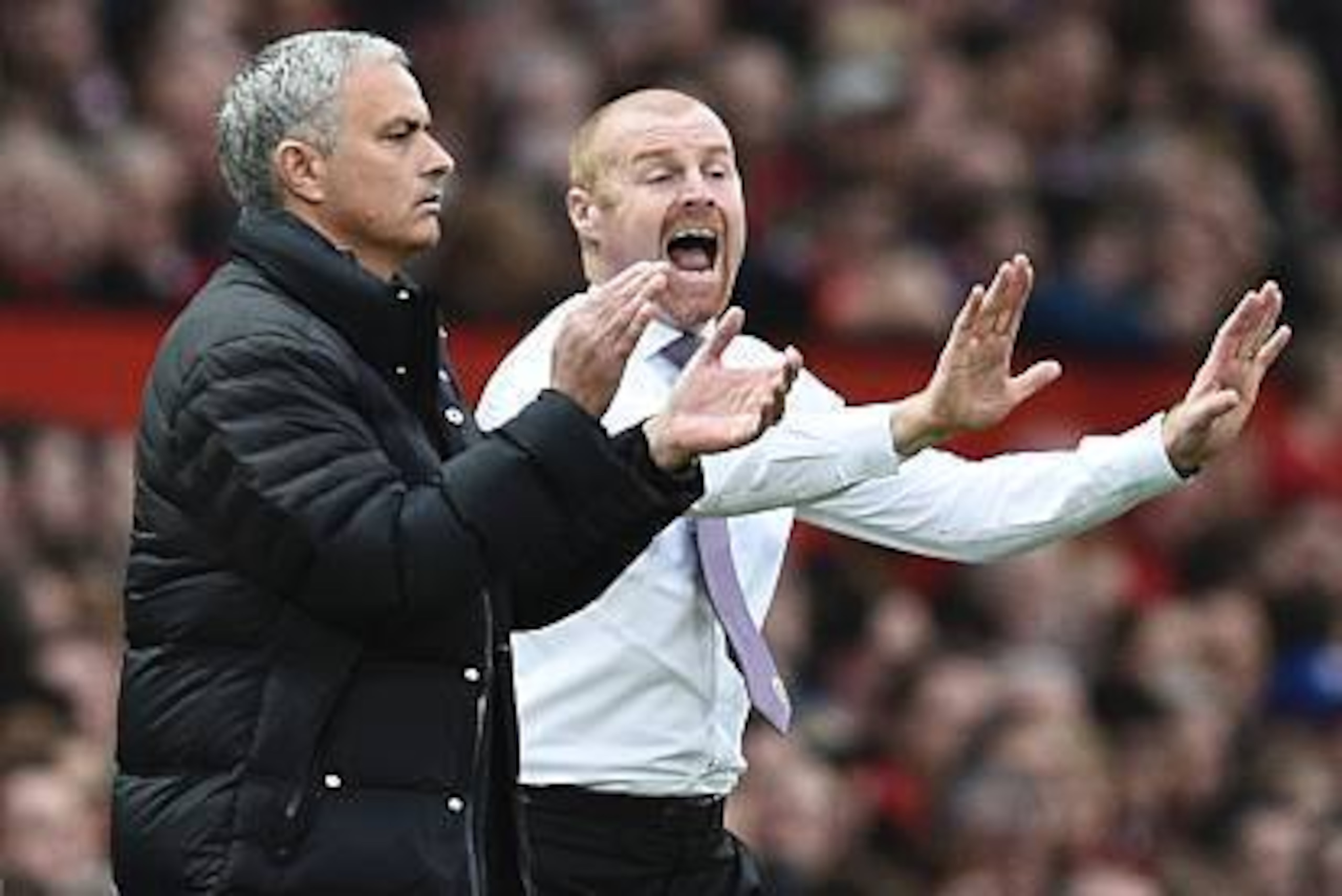 Manchester United's Portuguese manager Jose Mourinho (L) and Burnley's English manager Sean Dyche (R) gestures to their respective players on the touchline during the English Premier League football match between Manchester United and Burnley at Old Traff