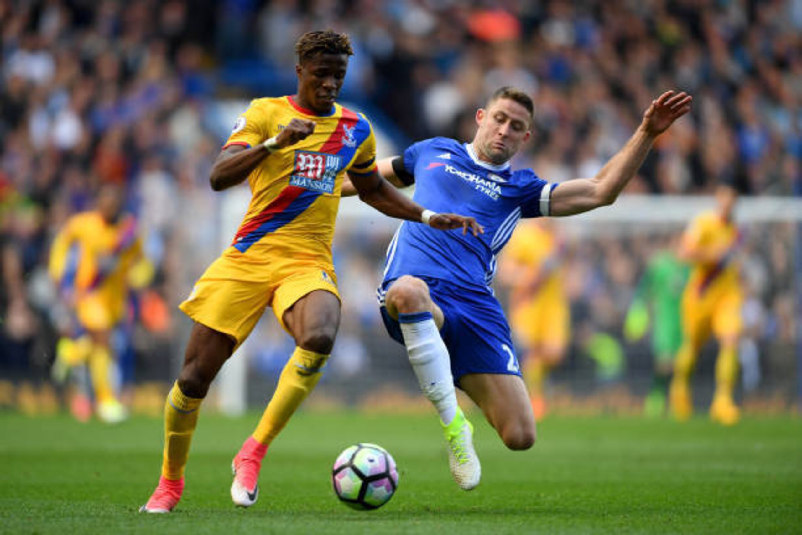LONDON, ENGLAND - APRIL 01:  Wilfried Zaha of Crystal Palace (L) is tackled by Gary Cahill of Chelsea (R) during the Premier League match between Chelsea and Crystal Palace at Stamford Bridge on April 1, 2017 in London, England.  (Photo by Mike Hewitt/Get