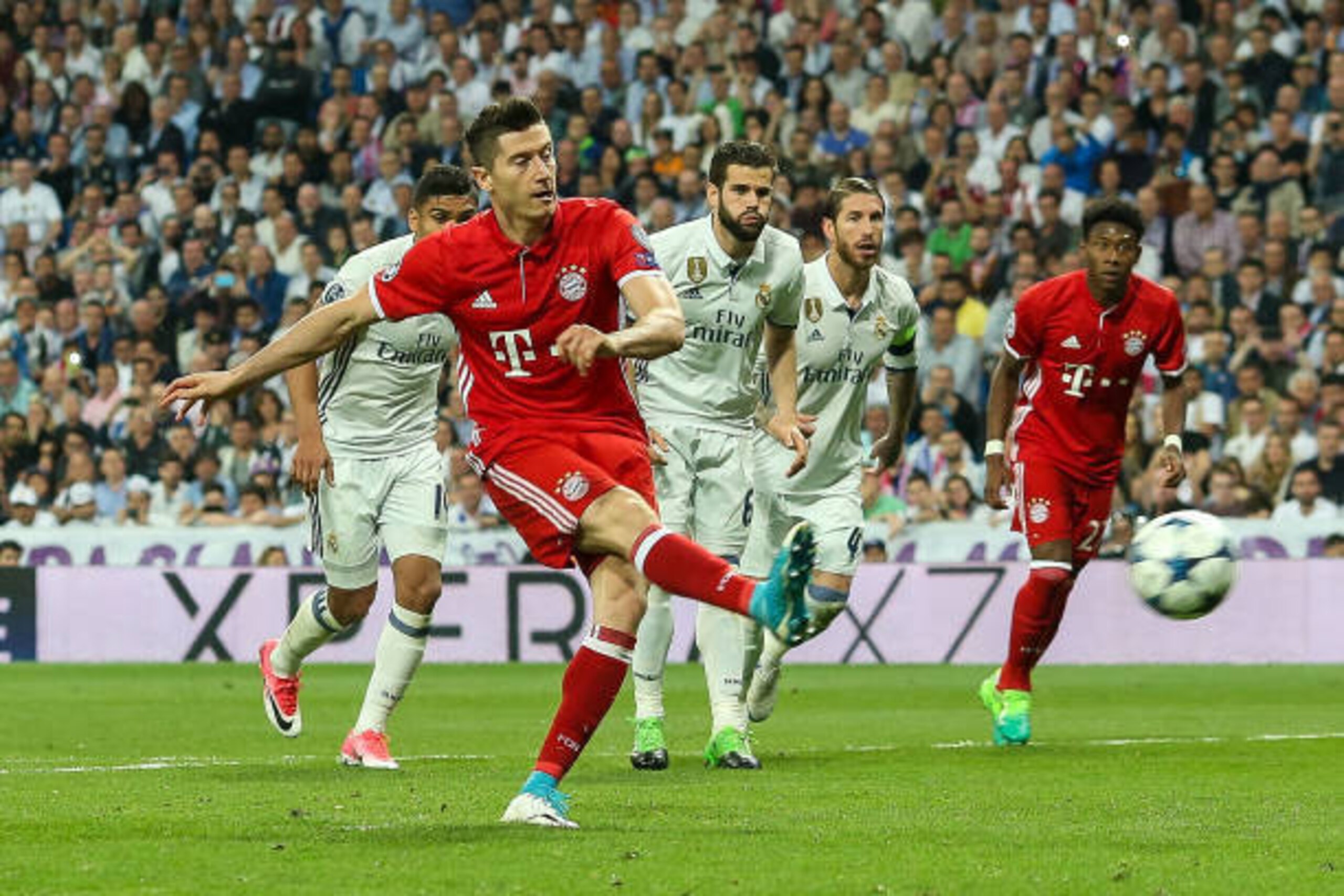 MADRID, SPAIN - APRIL 18: Robert Lewandowski of Bayern Muenchen scores his sides first goal from the penalty spot during the UEFA Champions League Quarter Final second leg match between Real Madrid CF and FC Bayern Muenchen at Estadio Santiago Bernabeu on MADRID, SPAIN - APRIL 18: Robert Lewandowski of Bayern Muenchen scores his sides first goal from the penalty spot during the UEFA Champions League Quarter Final second leg match between Real Madrid CF and FC Bayern Muenchen at Estadio Santiago Bernabeu on