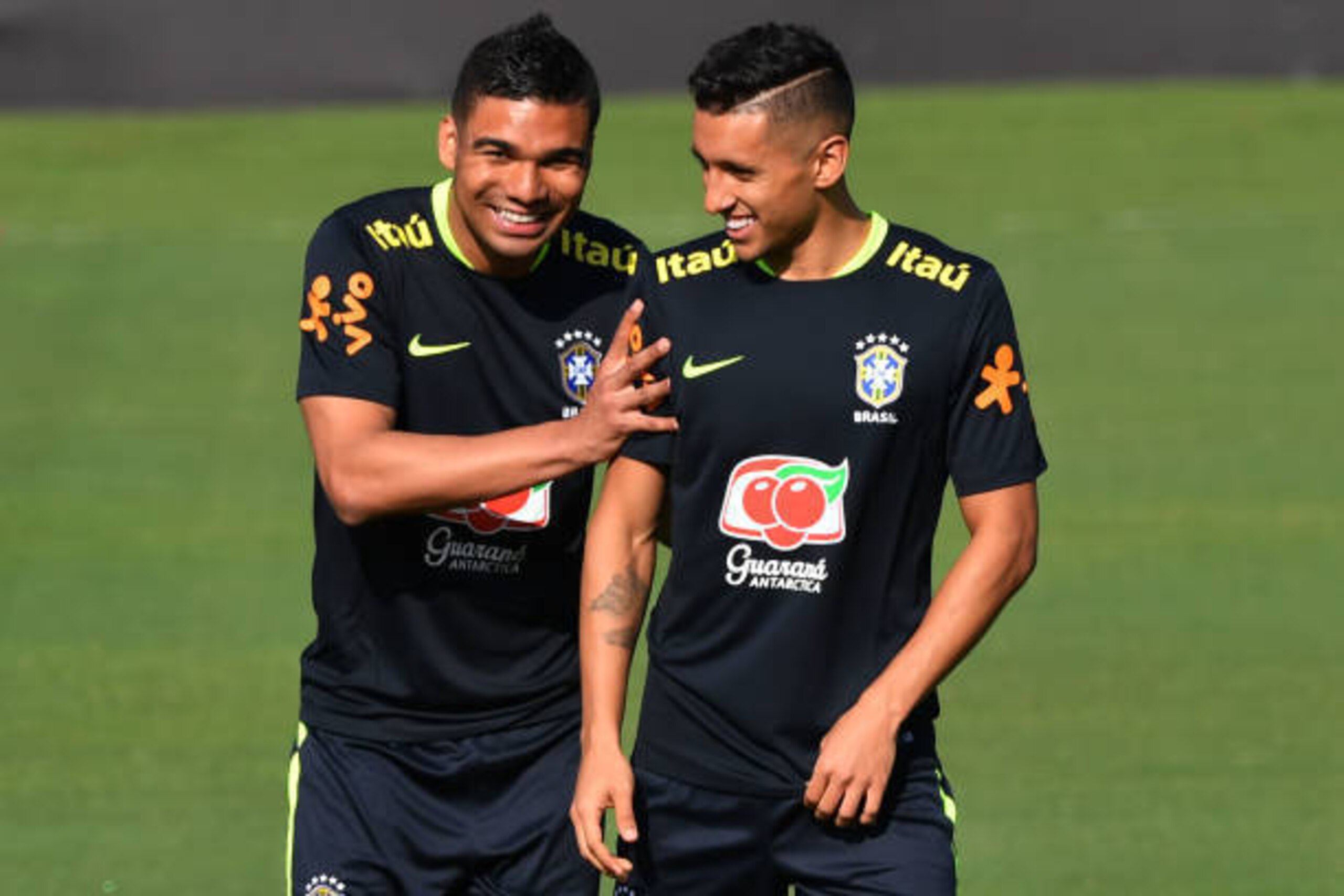 Brazil's footballers Casemiro (L) and Marquinhos joke during a training session at the Corinthians team training centre in Sao Paulo, Brazil, on March 21, 2017 ahead of their World Cup qualifier matches against Uruguay and Paraguay. / AFP PHOTO / Nelson A