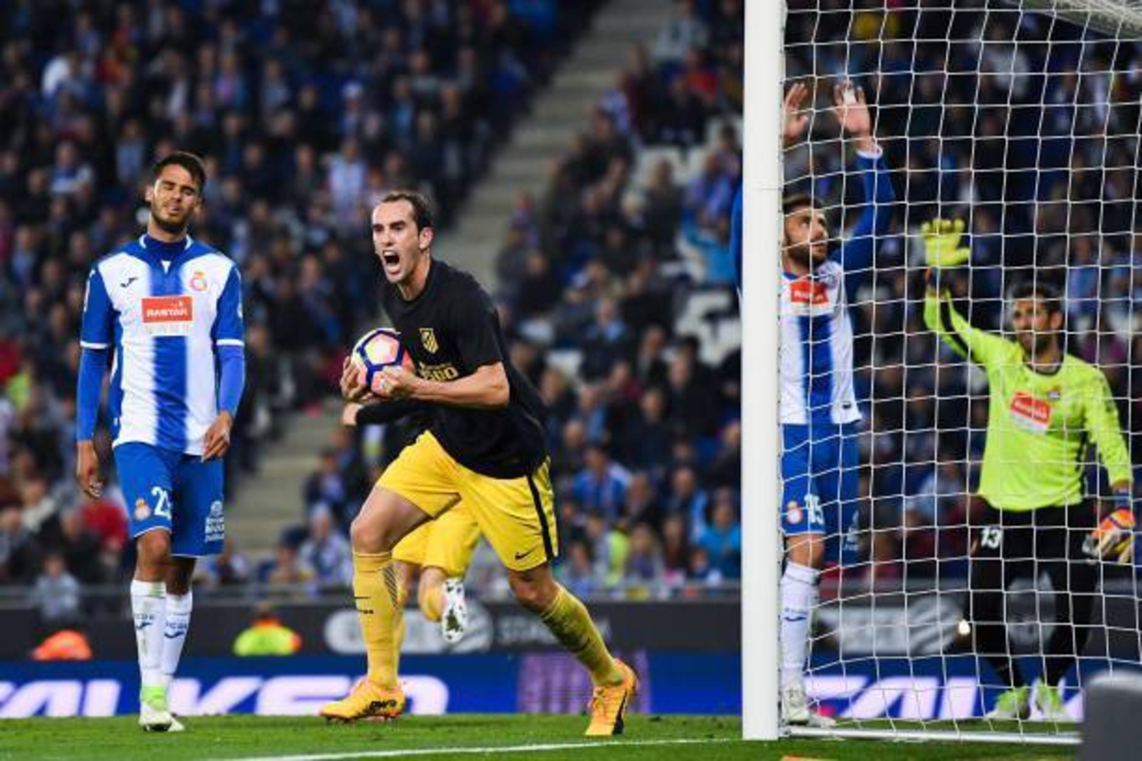 BARCELONA, SPAIN - APRIL 22:  Diego Godin of Club Atletico de Madrid celebrates after his team mate Antoine Griezmann of Club Atletico de Madrid scored the opening goal during the La Liga match between RCD Espanyol and Club Atletico de Madrid at the Corne