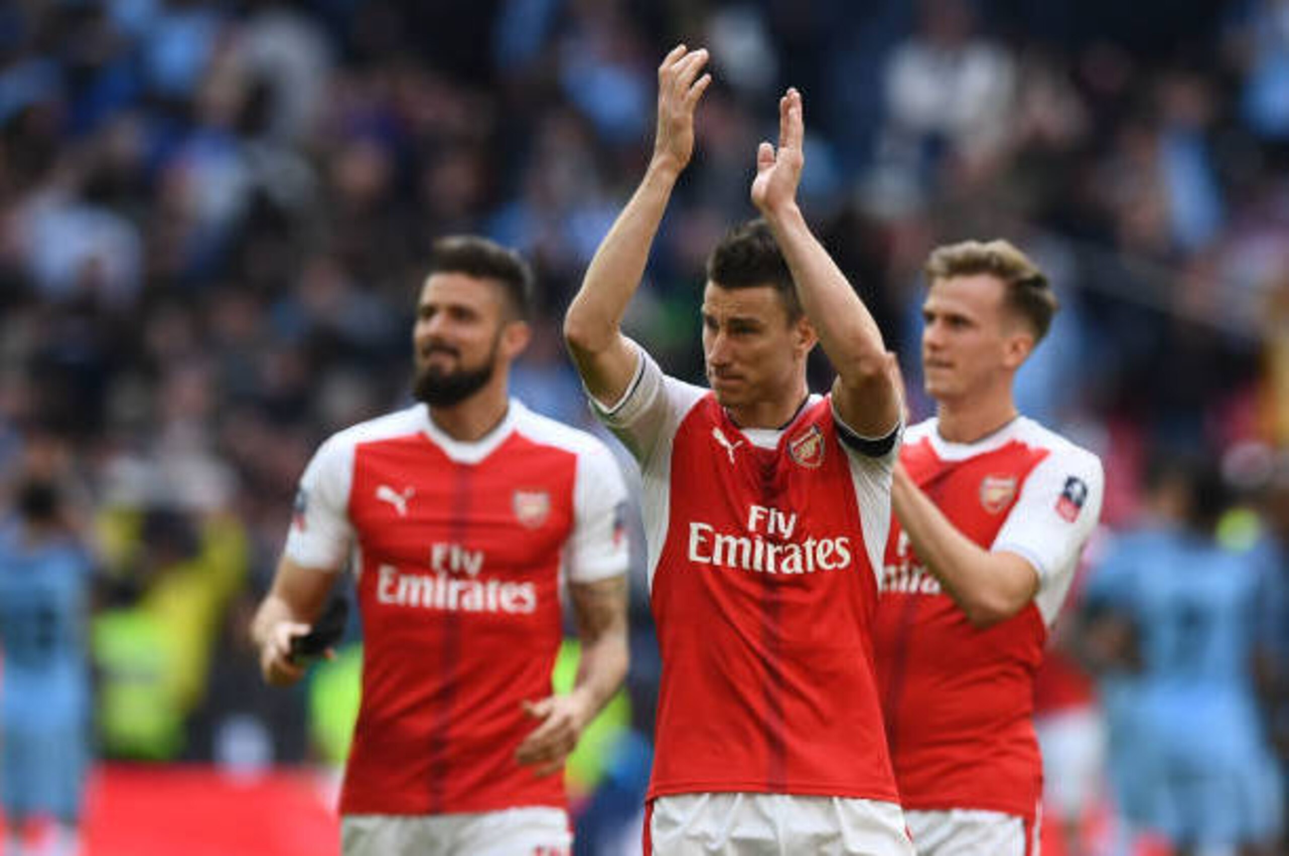 Arsenal's French striker Olivier Giroud, (L), Arsenal's French defender Laurent Koscielny (C) and Arsenal's English defender Rob Holding celebrate victory after the FA Cup semi-final football match between Arsenal and Manchester City at Wembley stadium in