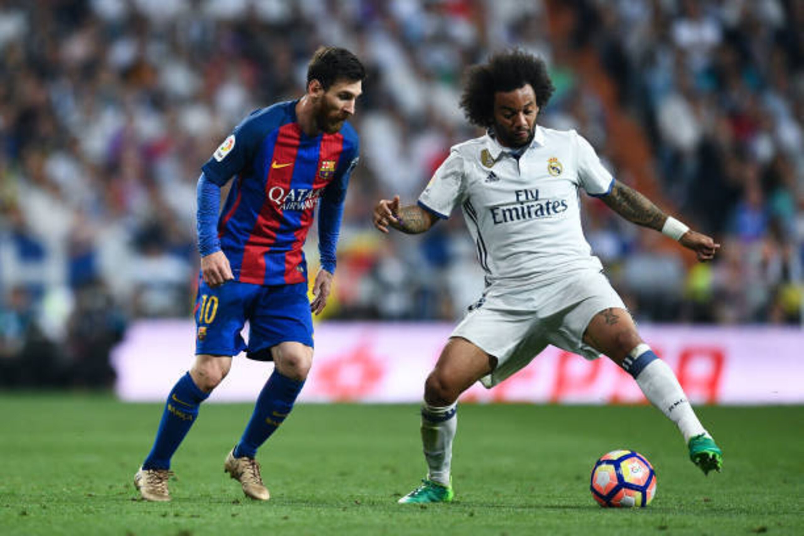 MADRID, SPAIN - APRIL 23:  Lionel Messi of FC Barcelona competes for the ball with Marcelo Vieira of Real Madrid CF during the La Liga match between Real Madrid CF and FC Barcelona at the Santiago Bernabeu stadium on April 23, 2017 in Madrid, Spain.  (Pho