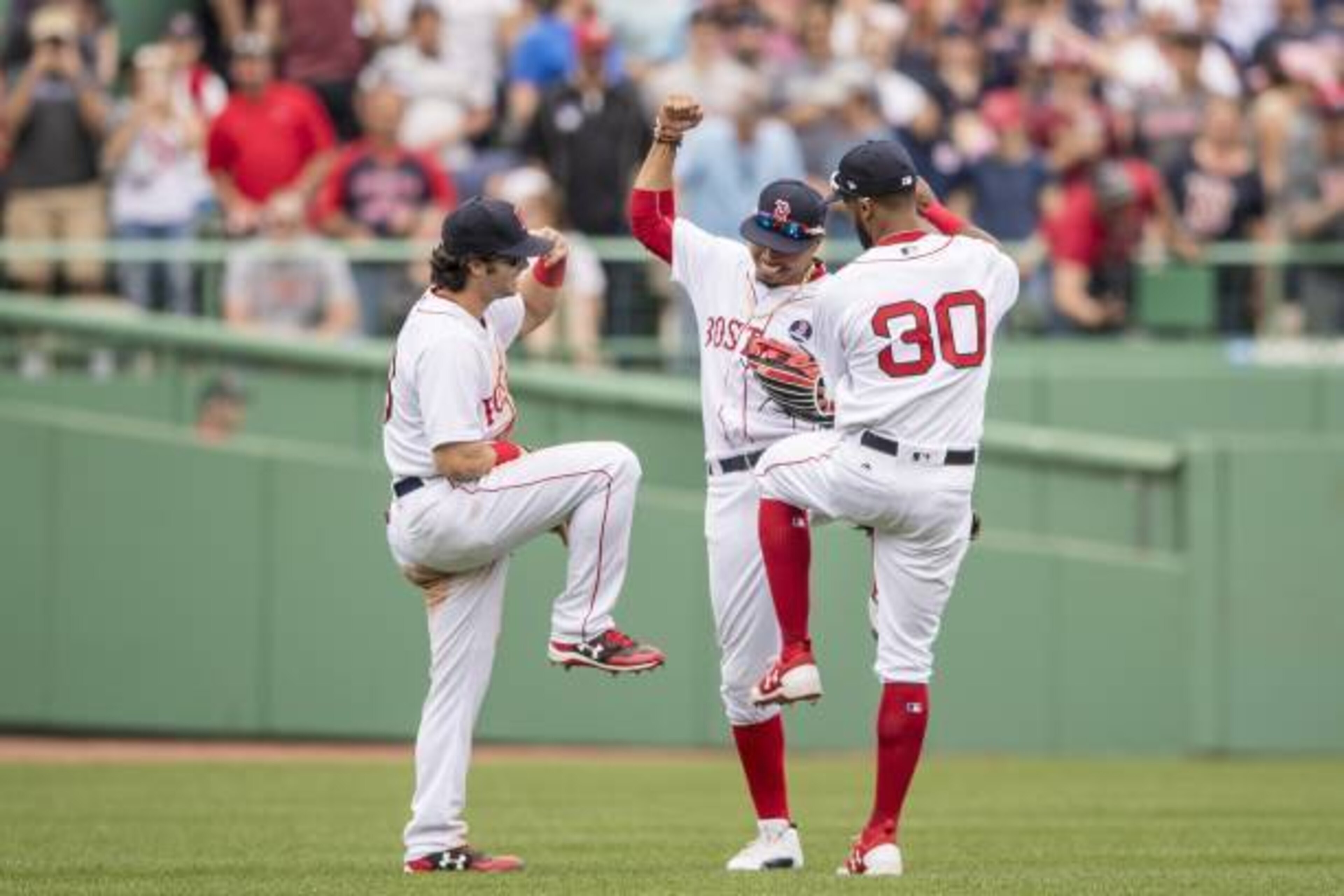 BOSTON, MA - APRIL 17: Andrew Benintendi #16, Mookie Betts #50, and Chris Young #30 of the Boston Red Sox celebrate a victory against the Tampa Bay Rays on April 17, 2017 at Fenway Park in Boston, Massachusetts. (Photo by Billie Weiss/Boston Red Sox/Getty