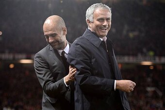 Manchester United's Portuguese manager Jose Mourinho (R) and Manchester City's Spanish manager Pep Guardiola share a joke ahead of the EFL (English Football League) Cup fourth round match between Manchester United and Manchester City at Old Trafford in Ma