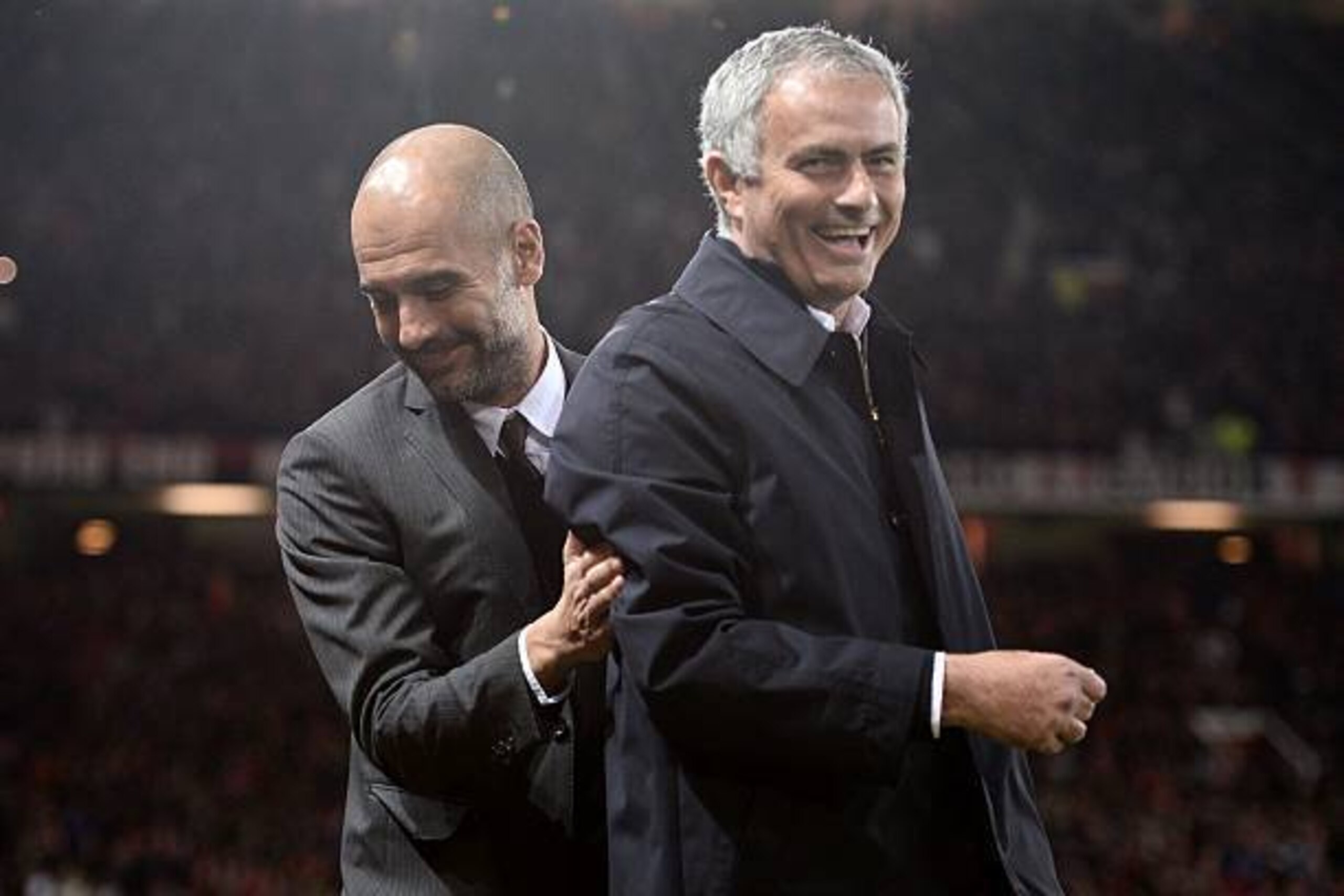Manchester United's Portuguese manager Jose Mourinho (R) and Manchester City's Spanish manager Pep Guardiola share a joke ahead of the EFL (English Football League) Cup fourth round match between Manchester United and Manchester City at Old Trafford in Ma
