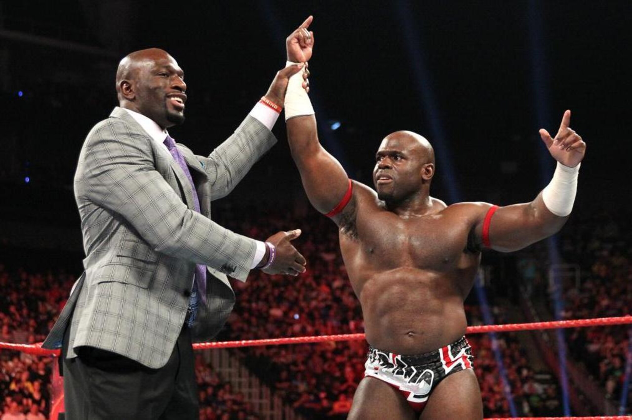 Titus O'Neil celebrates with Apollo Crews.
