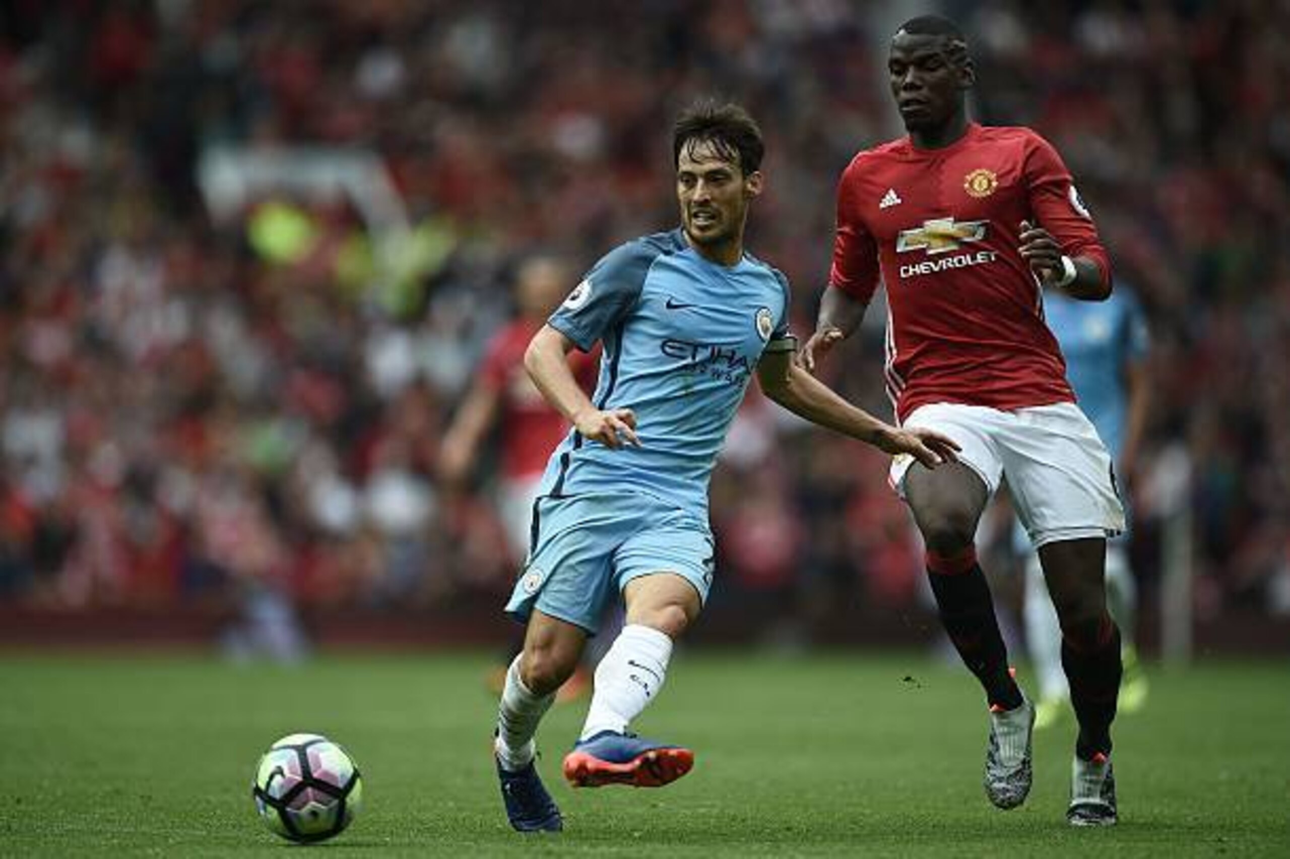 Manchester City's Spanish midfielder David Silva (L) vies with Manchester United's French midfielder Paul Pogba during the English Premier League football match between Manchester United and Manchester City at Old Trafford in Manchester, north west Englan