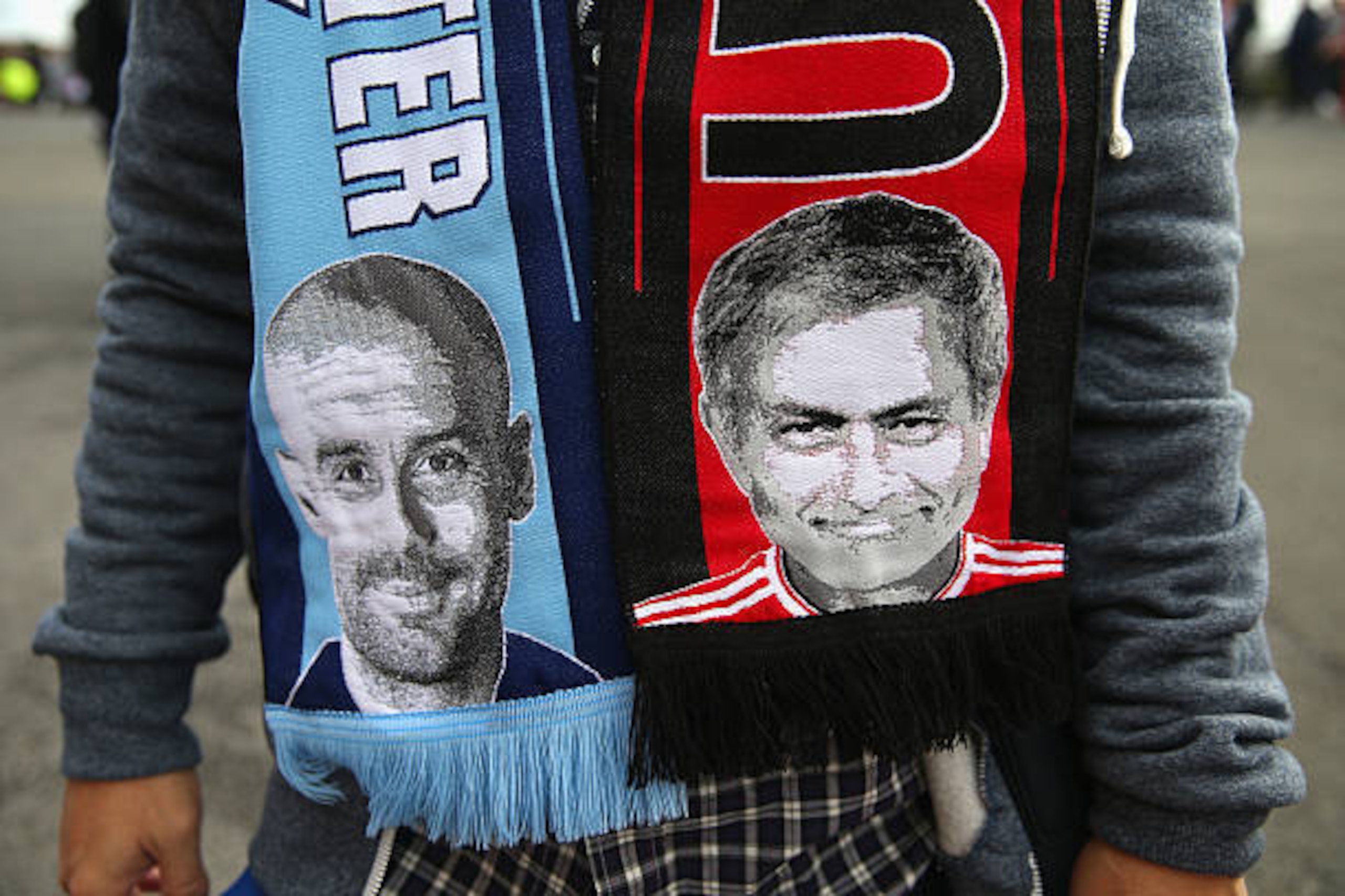 MANCHESTER, ENGLAND - SEPTEMBER 10:  Images of Pep Guardiola the manager of Manchester City and Jose Mourinho of Manchester United are seen on a scarf ahead of the Premier League match between Manchester United and Manchester City at Old Trafford on Septe