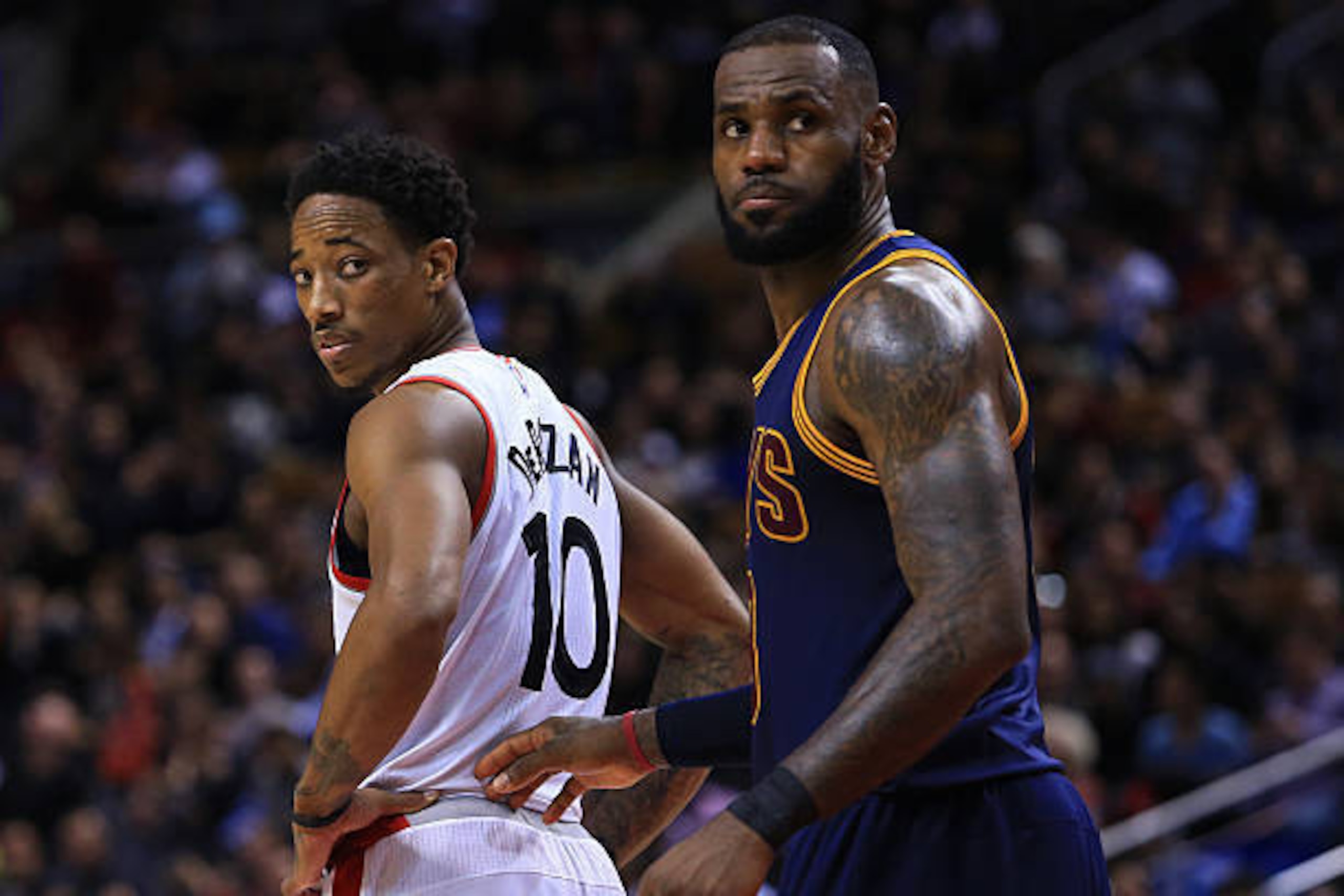 TORONTO, ON - DECEMBER 05:  Lebron James #23 of the Cleveland Cavaliers and DeMar DeRozan #10 of the Toronto Raptors look on during the second half of an NBA game at Air Canada Centre on December 5, 2016 in Toronto, Canada.  NOTE TO USER: User expressly a