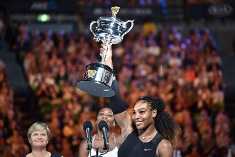 Serena Williams of the US celebrates with the championship trophy during the awards ceremony after her victory against Venus Williams of the US in the women's singles final on day 13 of the Australian Open tennis tournament in Melbourne on January 28, 201
