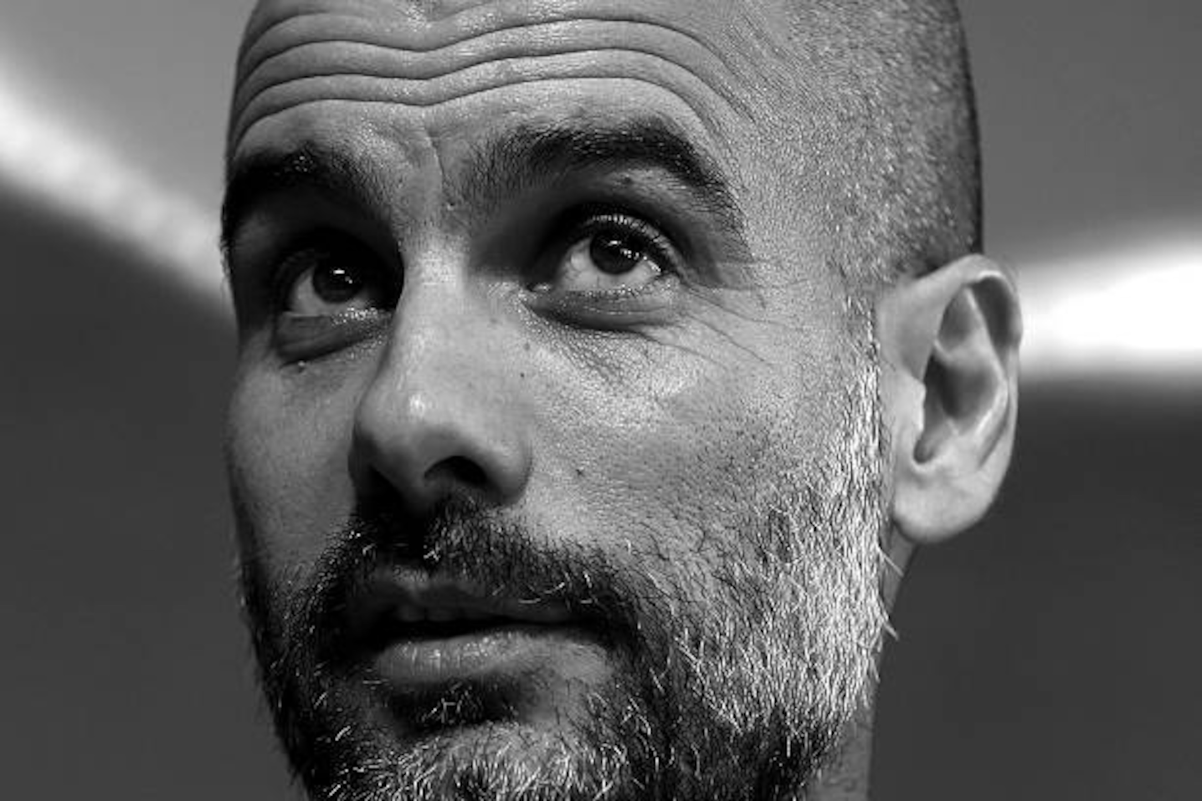 MANCHESTER, ENGLAND - OCTOBER 31: (EDITOR'S NOTE: THIS IMAGE HAS BEEN CONVERTED TO BLACK AND WHITE) Manchester City manager Josep Guardiola speaks during a press conference ahead of the UEFA Champions League match between Manchester City and Barcelona at 