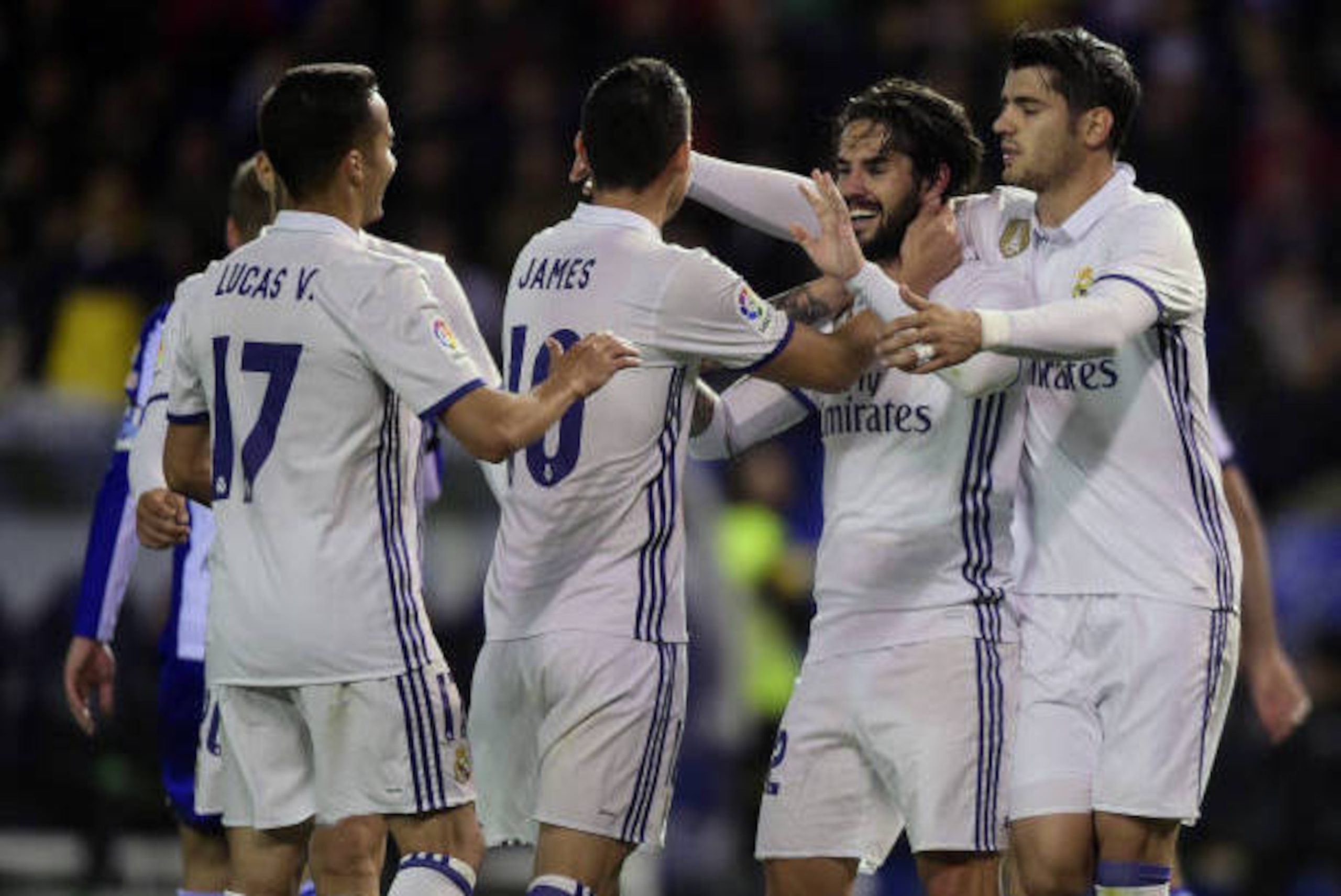 Real Madrid's midfielder Isco (2R) celebrates with teammates after scoring a goal during the Spanish league football match RC Deportivo vs Real Madrid CF at the Municipal de Riazor stadium in La Coruna on April 26, 2017. / AFP PHOTO / MIGUEL RIOPA        