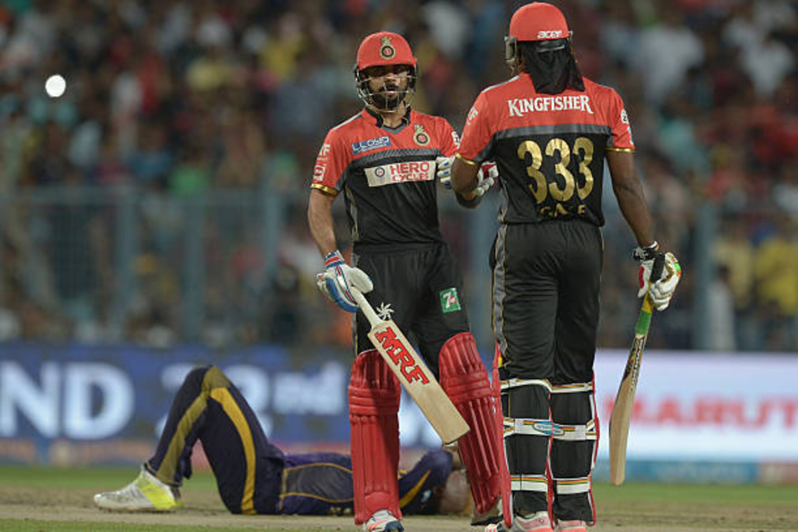 Royal Challengers Bangalore captain Virat Kohli (L) talks with Chris Gayle as Kolkata Knight Riders Andre Russell falls during the 2016 Indian Premier League (IPL) Twenty20 cricket match between Kolkata Knight Riders and Royal Challengers Bangalore at th Royal Challengers Bangalore captain Virat Kohli (L) talks with Chris Gayle as Kolkata Knight Riders Andre Russell falls during the 2016 Indian Premier League (IPL) Twenty20 cricket match between Kolkata Knight Riders and Royal Challengers Bangalore at th