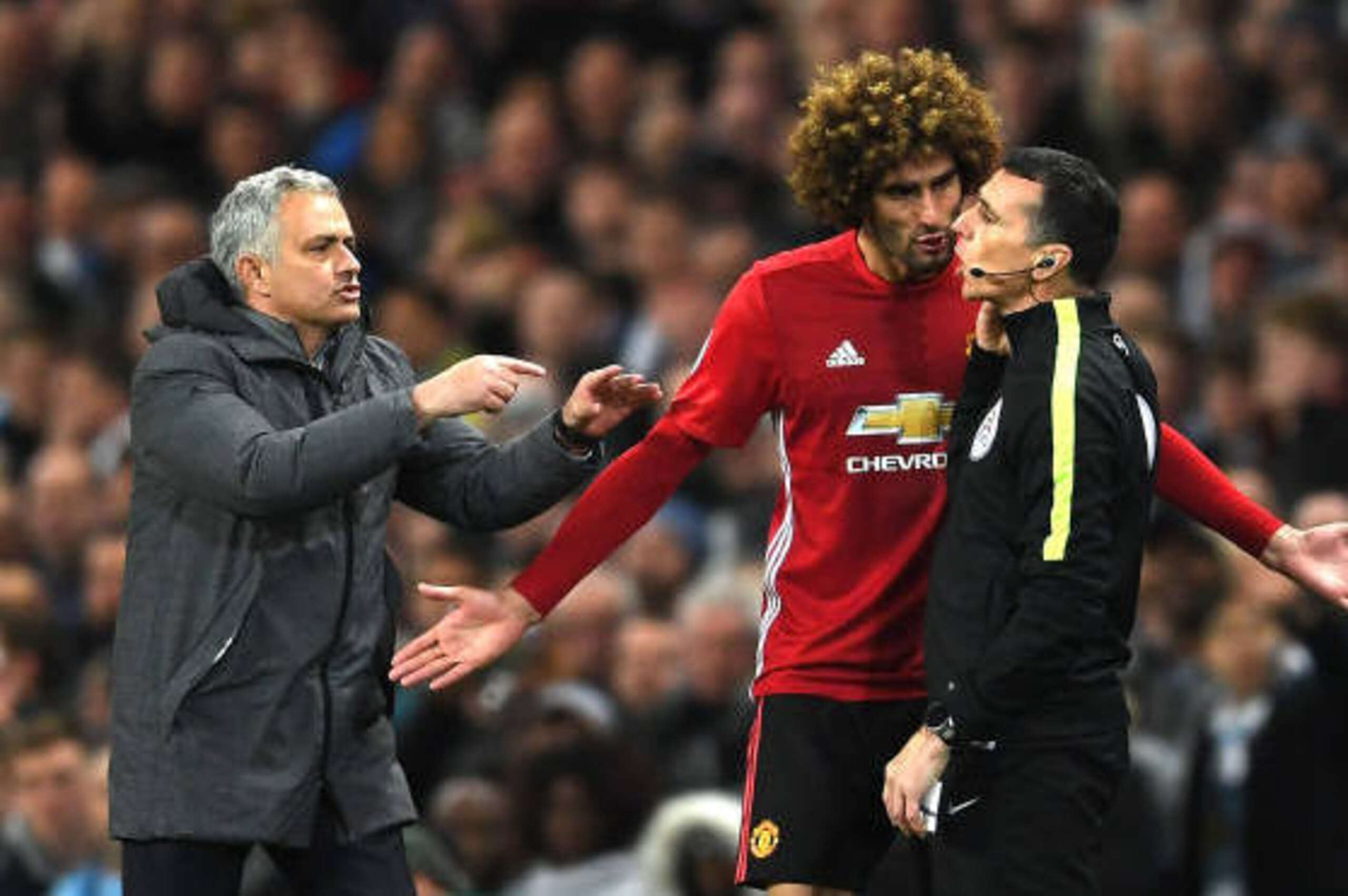 MANCHESTER, ENGLAND - APRIL 27:  Marouane Fellaini of Manchester United and Jose Mourinho, Manager of Manchester United protest to the 4th official following his sending off during the Premier League match between Manchester City and Manchester United at 