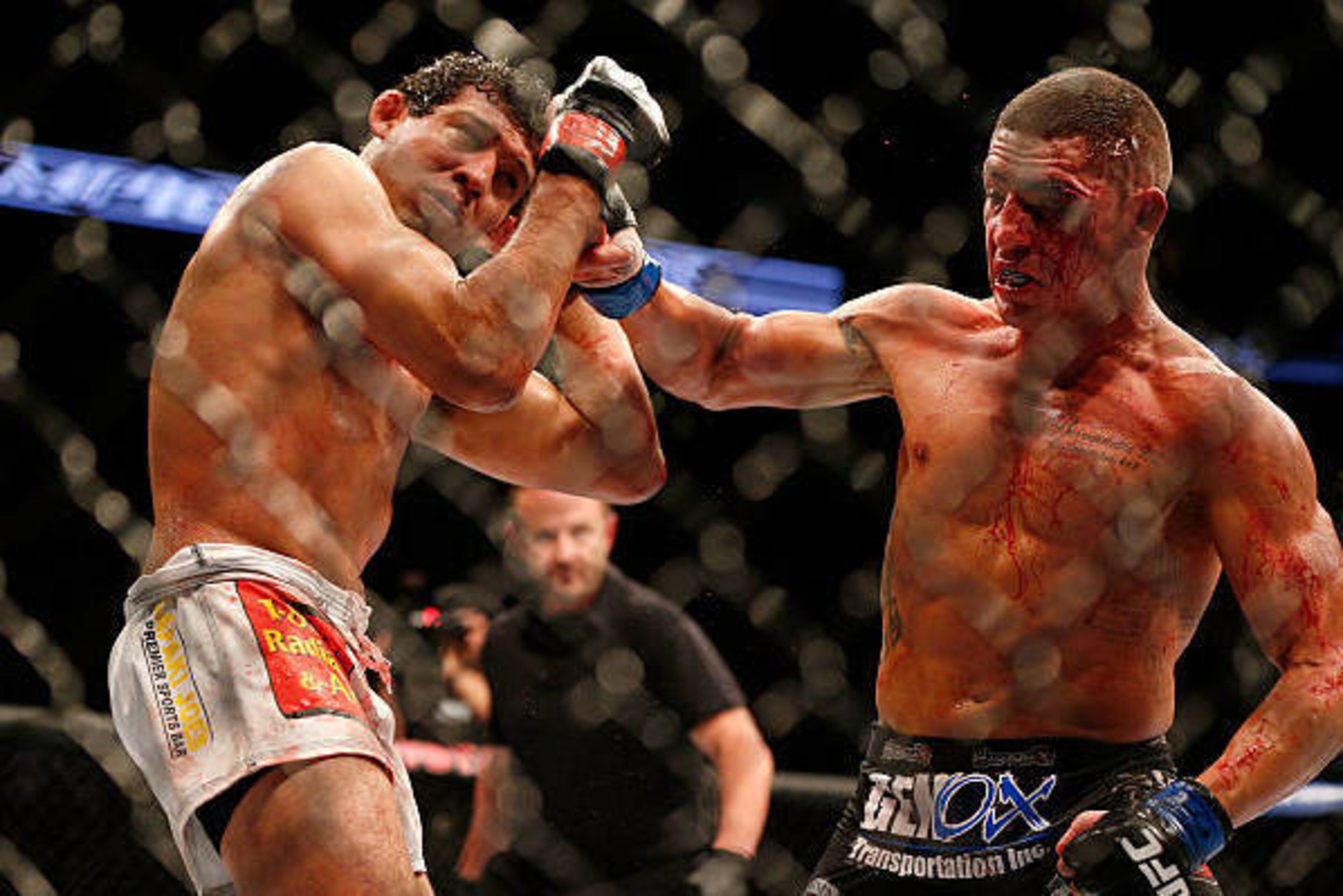 HOUSTON, TEXAS - OCTOBER 19:  (R-L) Diego Sanchez punches Gilbert Melendez in their UFC lightweight bout at the Toyota Center on October 19, 2013 in Houston, Texas. (Photo by Josh Hedges/Zuffa LLC/Zuffa LLC via Getty Images)