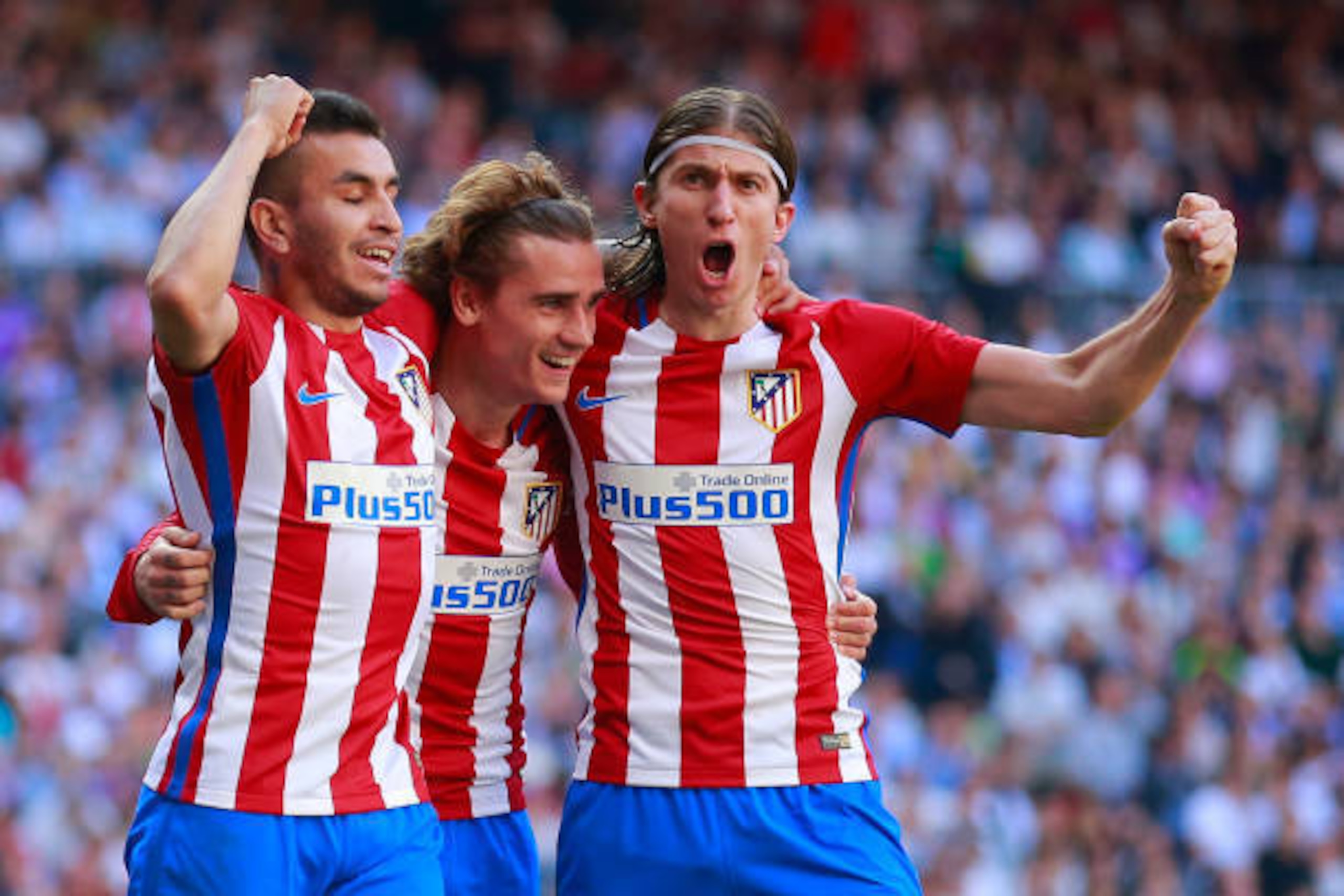 MADRID, SPAIN - APRIL 08:  Antoine Griezmann (2ndL) of Atletico de Madrid celebrates scoring their opening goal with teammates Angel Martin Correa (L) and Filipe Luis (R) during the La Liga match between Real Madrid CF and Club Atletico de Madrid at Estad