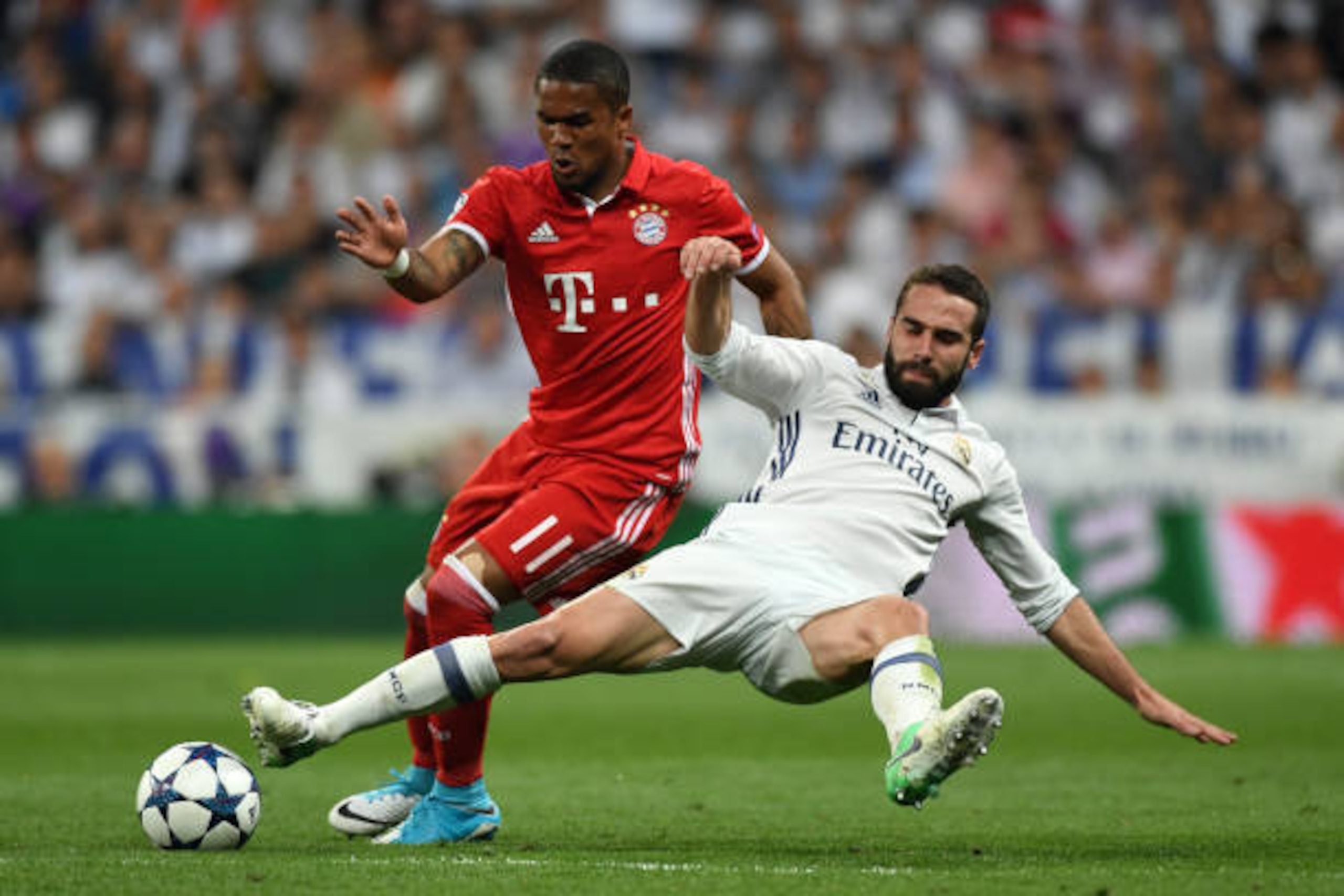 MADRID, SPAIN - APRIL 18: Douglas Costa of Bayern Muenchen and Dani Carvajal of Real Madrid compete for th e ball during the UEFA Champions League Quarter Final second leg match between Real Madrid CF and FC Bayern Muenchen at Estadio Santiago Bernabeu on