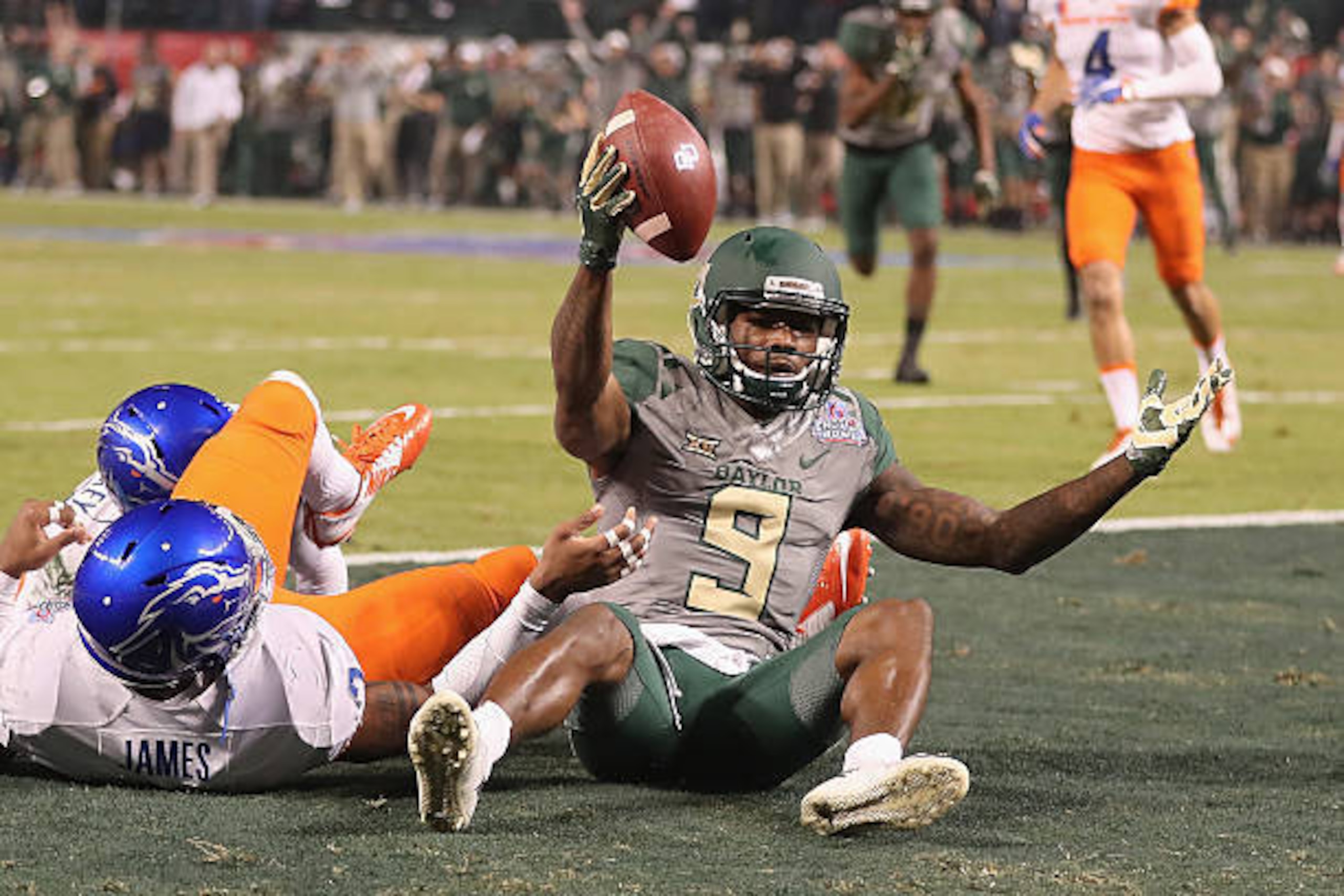 PHOENIX, AZ - DECEMBER 27:  Wide receiver KD Cannon #9 of the Baylor Bears reacts after scoring on a 30 yard touchdown reception past safety Chanceller James #3 of the Boise State Broncos during the first quarter of the Motel 6 Cactus Bowl at Chase Field 