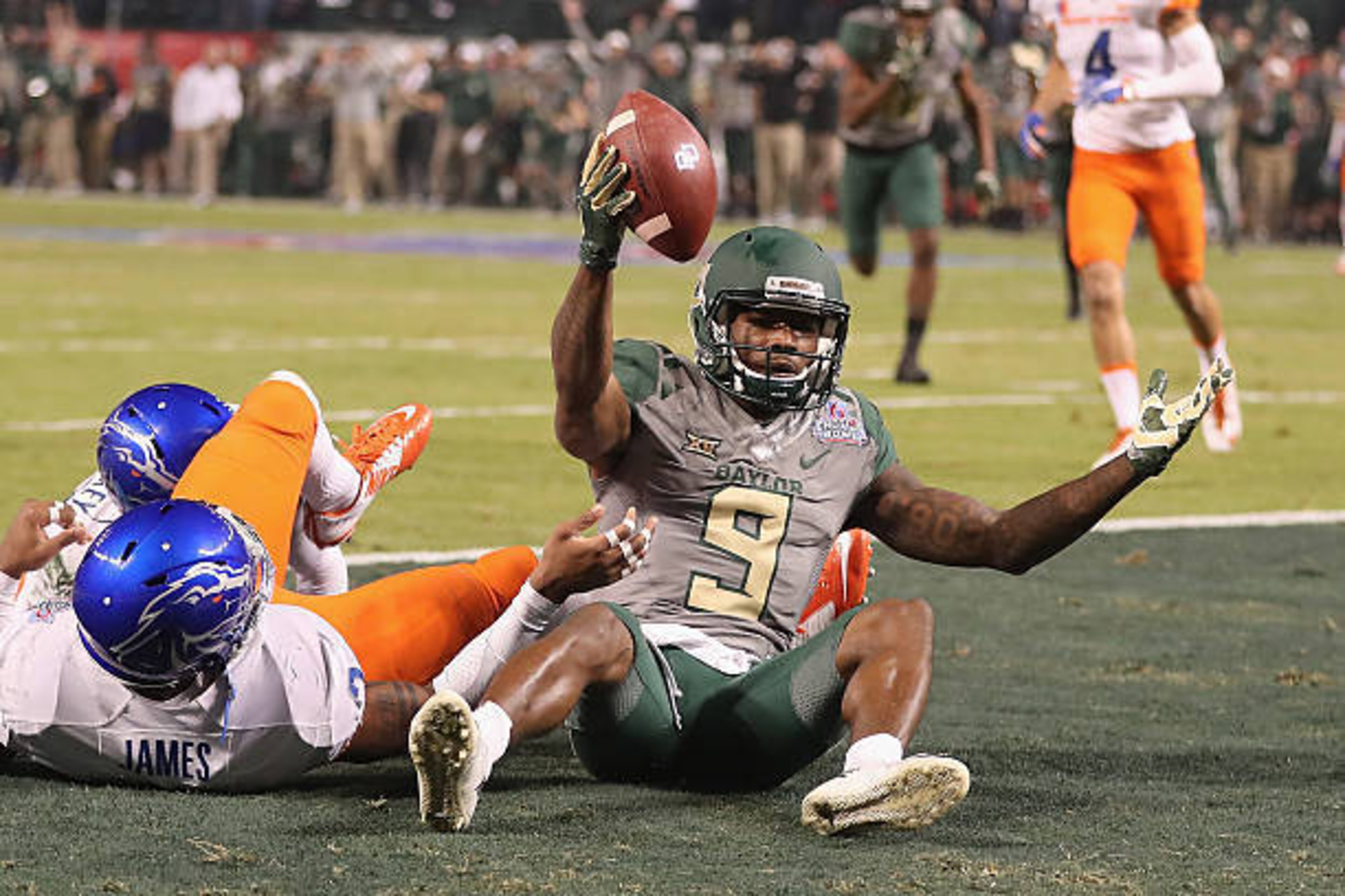 PHOENIX, AZ - DECEMBER 27:  Wide receiver KD Cannon #9 of the Baylor Bears reacts after scoring on a 30 yard touchdown reception past safety Chanceller James #3 of the Boise State Broncos during the first quarter of the Motel 6 Cactus Bowl at Chase Field 