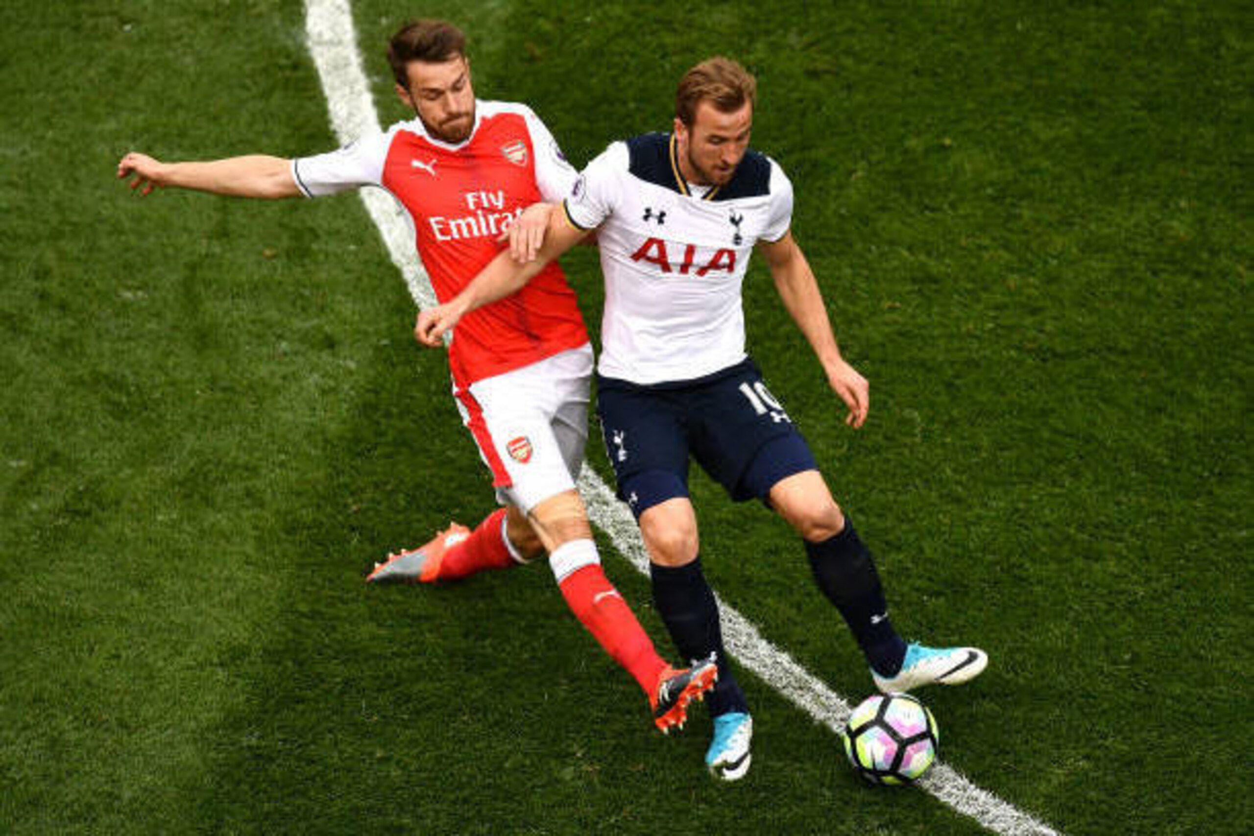 LONDON, ENGLAND - APRIL 30:  Aaron Ramsey of Arsenal tackles Harry Kane of Tottenham Hotspur during the Premier League match between Tottenham Hotspur and Arsenal at White Hart Lane on April 30, 2017 in London, England.  (Photo by Dan Mullan/Getty Images)
