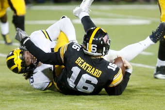 IOWA CITY, IOWA- NOVEMBER 12:  Quarterback C.J. Beathard #16 of the Iowa Hawkeyes  is sacked by defensive end Chase Winovich #15 of the Michigan Wolverines during the fourth quarter on November 12, 2016 at Kinnick Stadium in Iowa City, Iowa.  (Photo by Ma