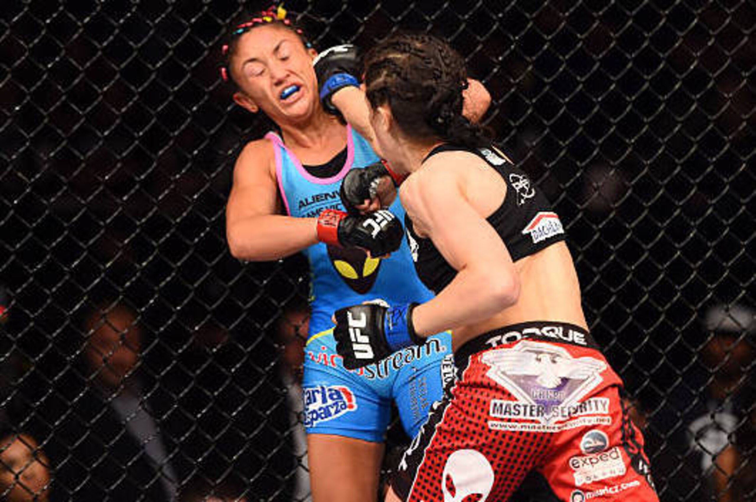 DALLAS, TX - MARCH 14:  (R-L) Joanna Jedrzejczyk punches Carla Esparza in their UFC women's strawweight championship bout during the UFC 185 event at the American Airlines Center on March 14, 2015 in Dallas, Texas. (Photo by Josh Hedges/Zuffa LLC/Zuffa LL