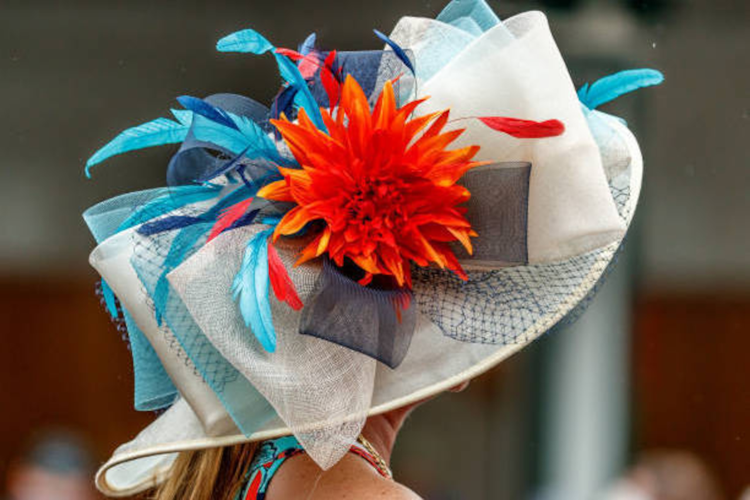 LOUISVILLE, KENTUCKY - MAY 04: A woman with a fashionable hat walks  near the paddock as she celebrates Thurby in the rain at Churchill Downs on May 4, 2017 in Louisville, Kentucky. (Photo by Jesse Caris/Eclipse Sportswire/Getty Images)