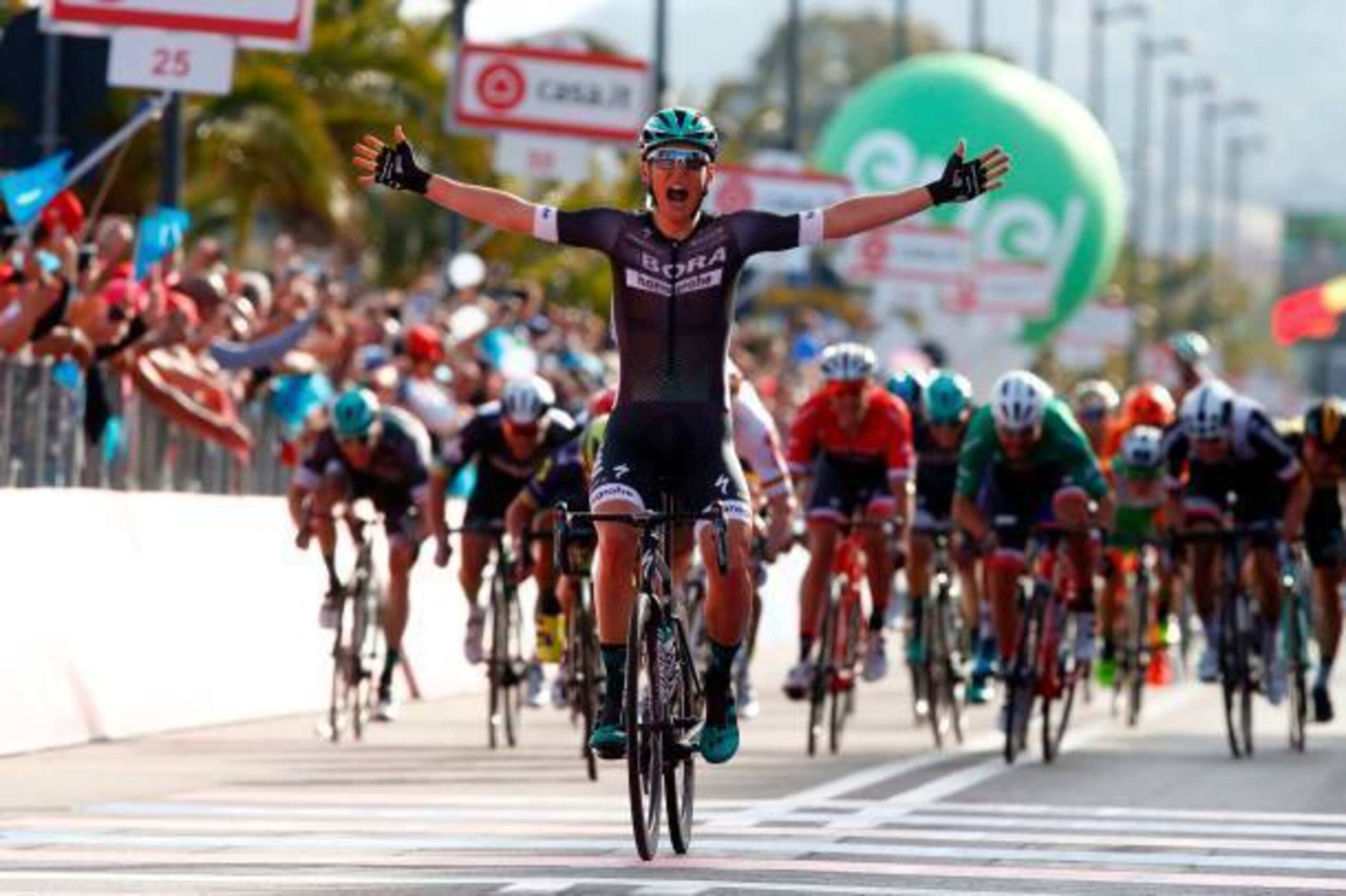 Austria's Lukas Postlberger celebrates as he crosses the finish line to win the first stage of the 100th Giro d'Italia, Tour of Italy, from Alghero to Olbia on May 5, 2017 in Sardinia.  / AFP PHOTO / Luk BENIES        (Photo credit should read LUK BENIES/