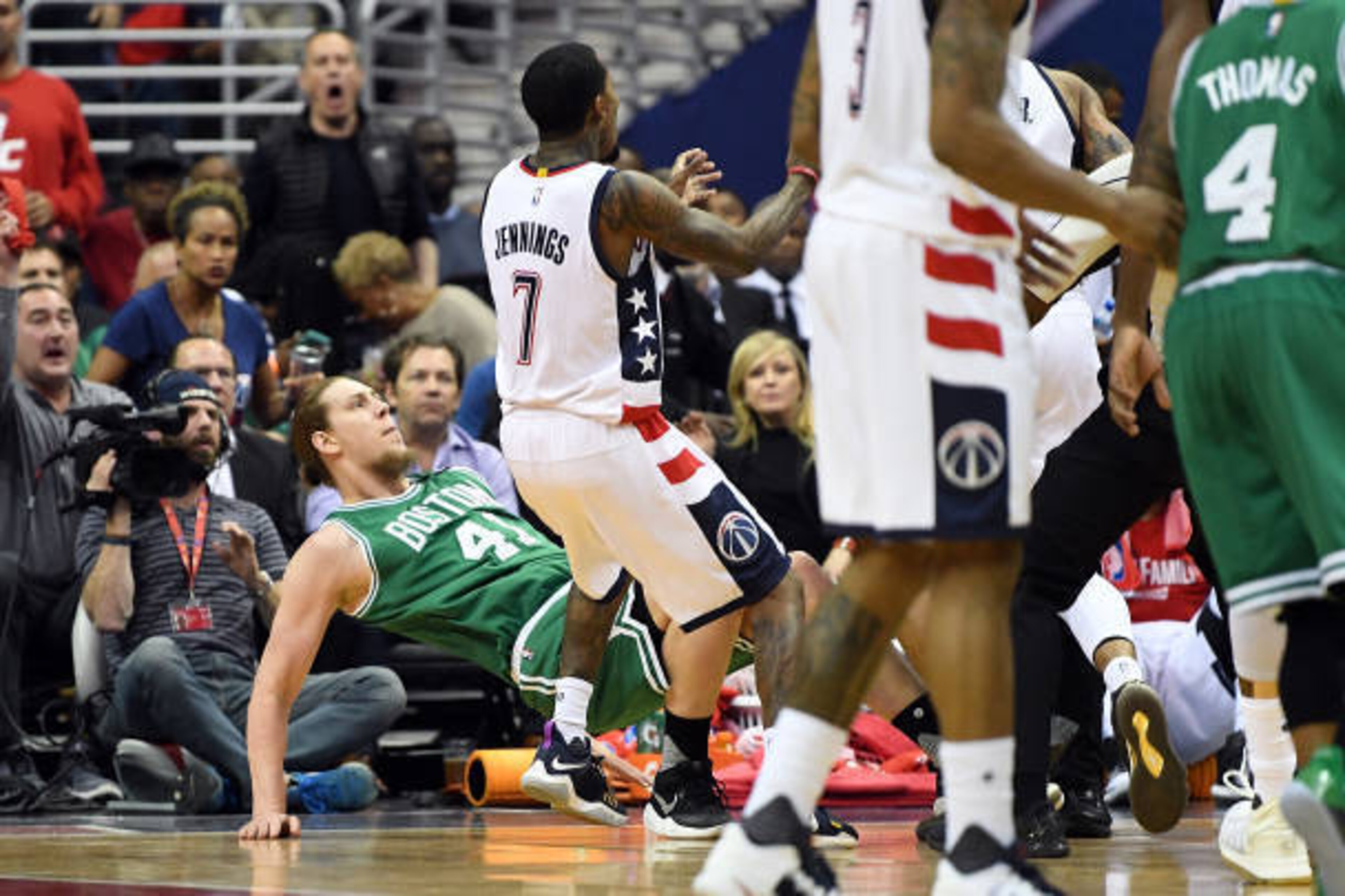 WASHINGTON, DC - MAY 04: Kelly Olynyk #41 of the Boston Celtics is knocked to the floor by Kelly Oubre Jr. #12 (not pictured) of the Washington Wizards in the second quarter during Game Three of the Eastern Conference Semifinals at Verizon Center on May 4