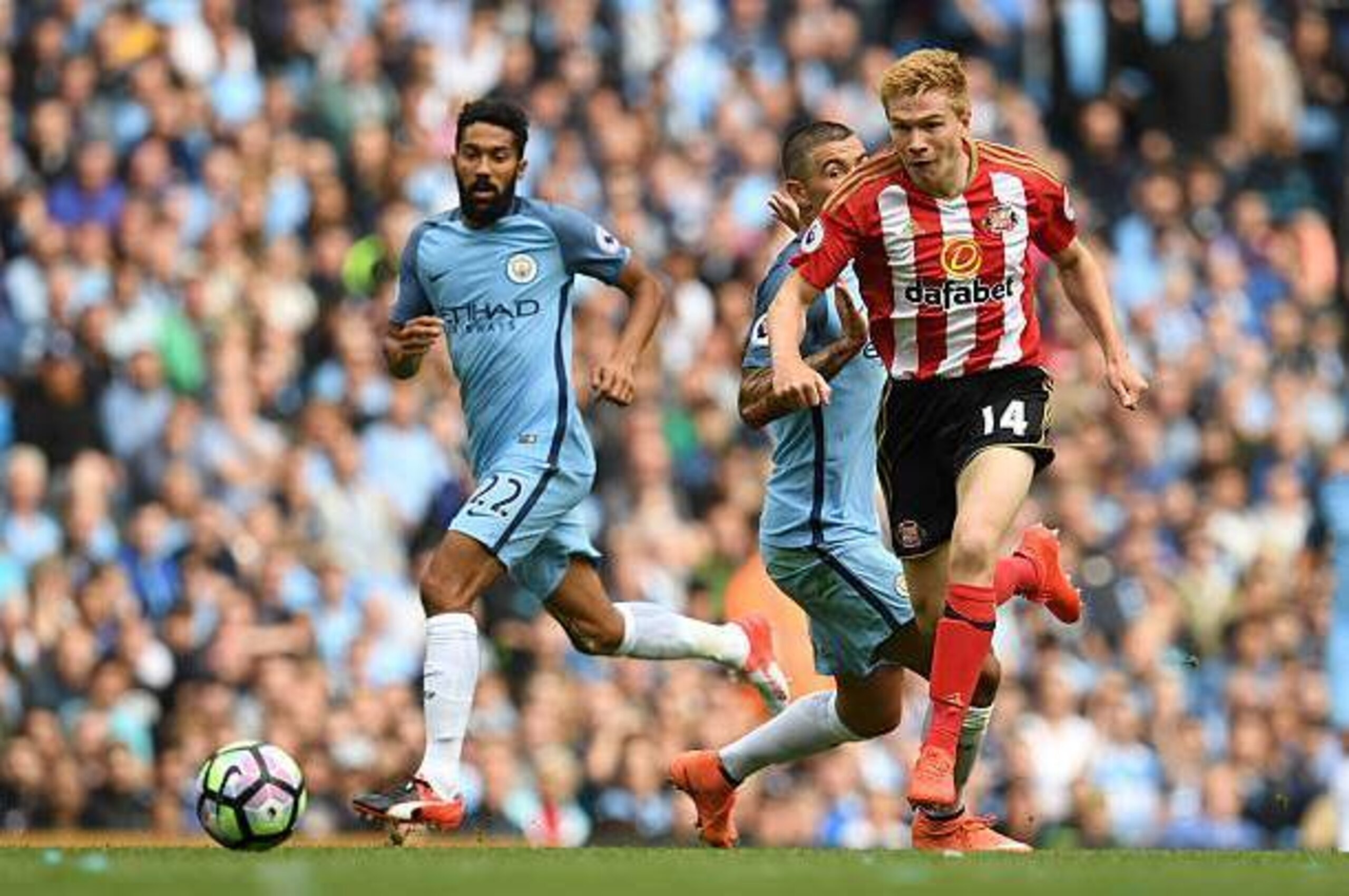 Sunderland's English striker Duncan Watmore (R) runs away from Manchester City's Serbian defender Aleksandar Kolarov (C) and Manchester City's French defender Gael Clichy (L) during the English Premier League football match between Manchester City and Sun