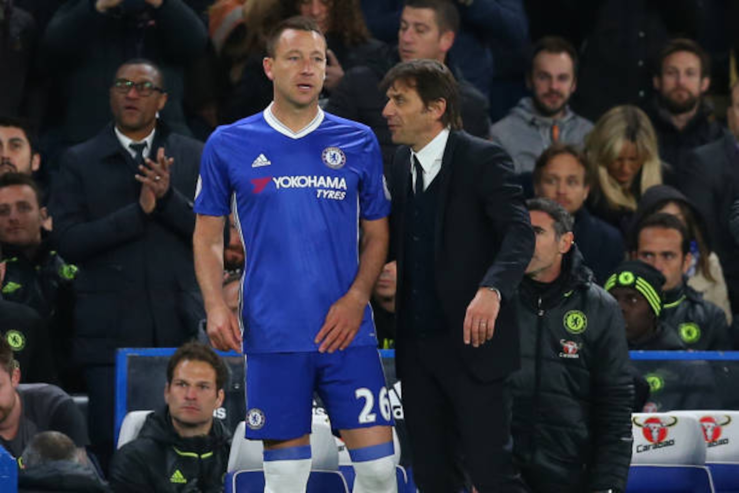 LONDON, ENGLAND - APRIL 25: Antonio Conte manager / head coach of Chelsea talks to John Terry of Chelsea as he waits to come on as substitute during the Premier League match between Chelsea and Southampton at Stamford Bridge on April 25, 2017 in London, E