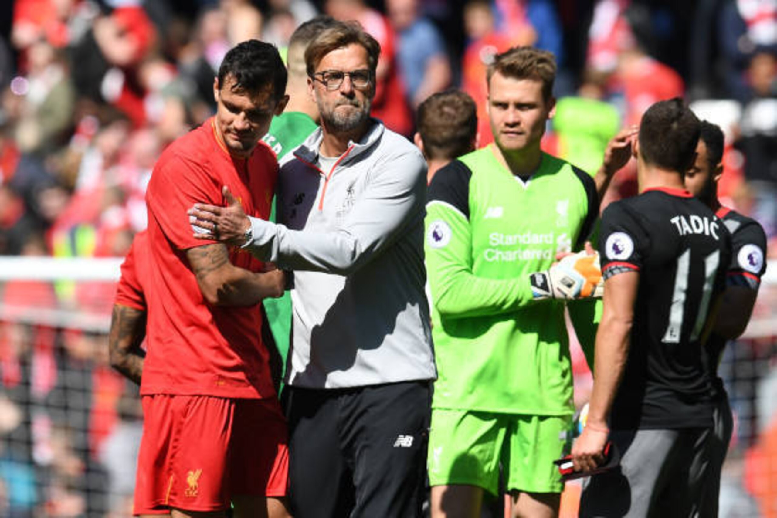 Liverpool's German manager Jurgen Klopp (C) embraces Liverpool's Croatian defender Dejan Lovren after the English Premier League football match between Liverpool and Southampton at Anfield in Liverpool, north west England on May 7, 2017. / AFP PHOTO / Pau