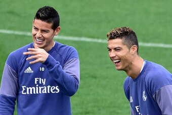 Real Madrid's Portuguese forward Cristiano Ronaldo (R) and Real Madrid's Colombian midfielder James Rodriguez laugh during a training session at Valdebebas training ground in Madrid on May 5, 2017, on the eve of the Spanish League match football match Gra