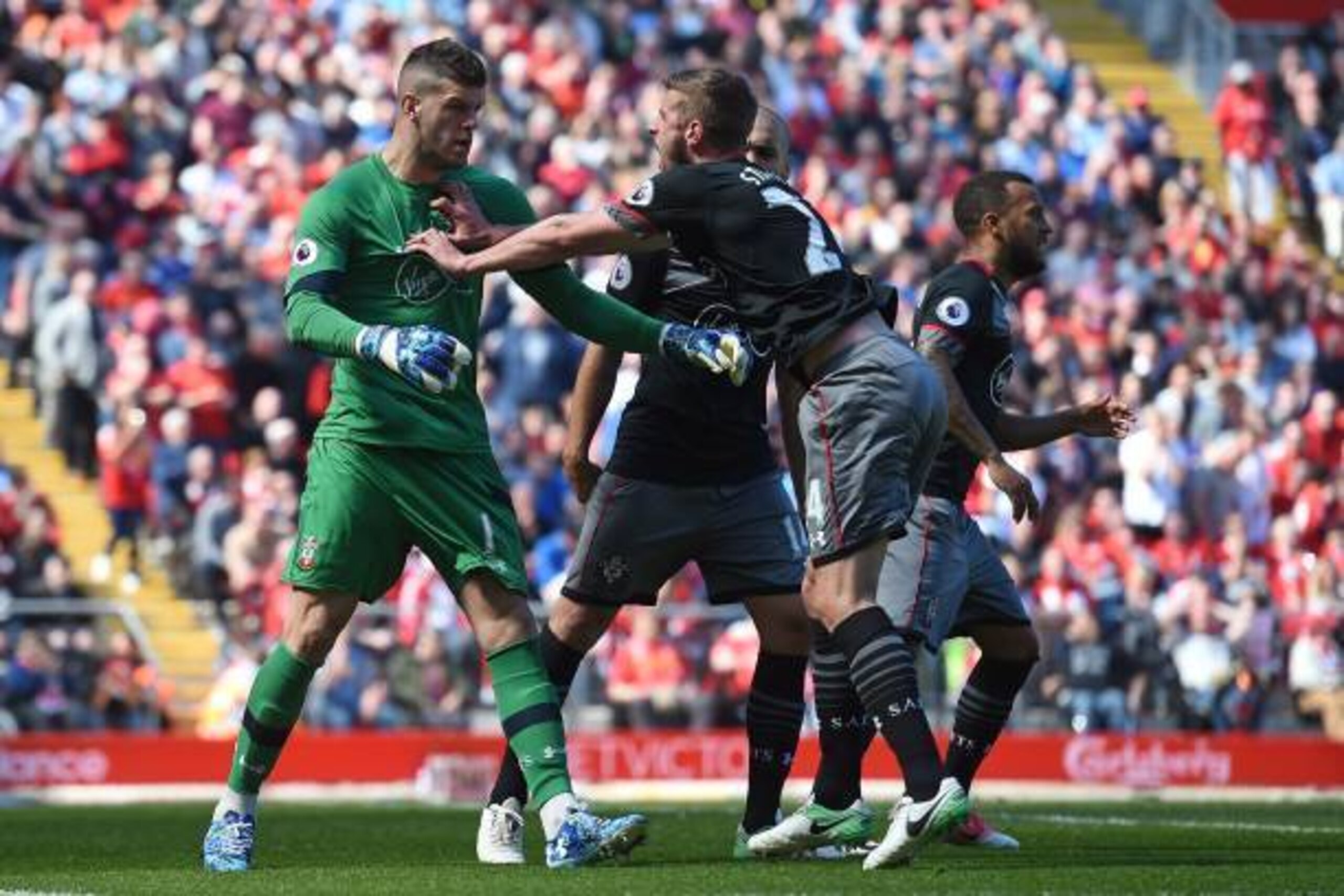 Southampton's English defender Jack Stephens (R) congratulates Southampton's English goalkeeper Fraser Forster after he saved a penalty during the English Premier League football match between Liverpool and Southampton at Anfield in Liverpool, north west 