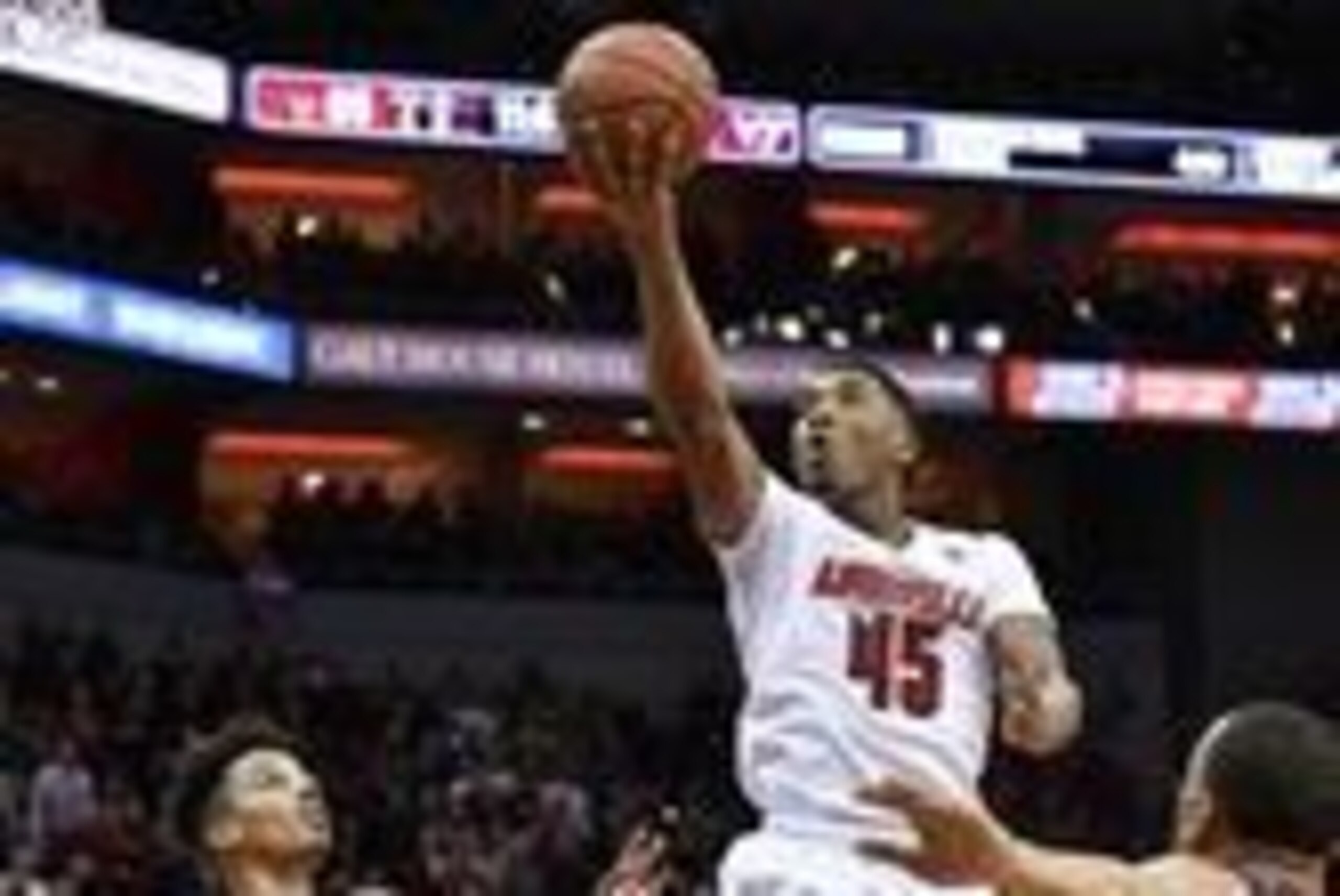 Feb 18, 2017; Louisville, KY, USA; Louisville Cardinals guard Donovan Mitchell (45) shoots against Virginia Tech Hokies guard Seth Allen (4) during the second half at KFC Yum! Center. Louisville defeated Virginia Tech 94-90.  Mandatory Credit: Jamie Rhode