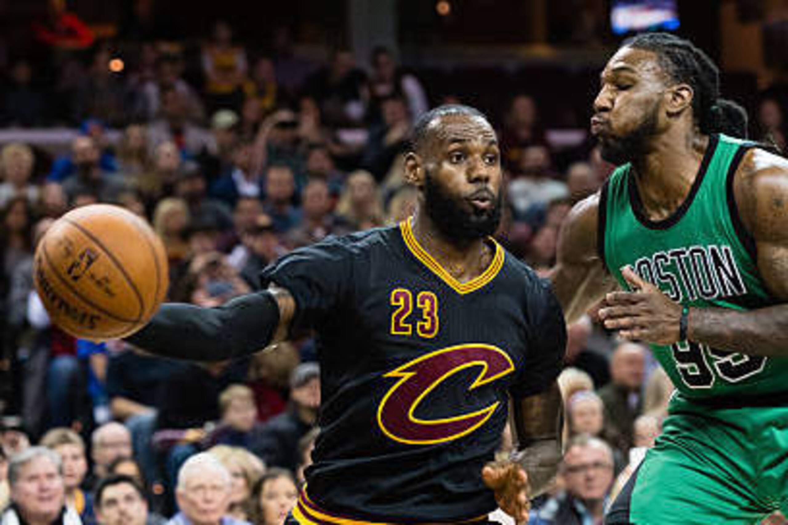 CLEVELAND, OH - DECEMBER 29: LeBron James #23 of the Cleveland Cavaliers passes around Jae Crowder #99 of the Boston Celtics during the first half at Quicken Loans Arena on December 29, 2016 in Cleveland, Ohio.  NOTE TO USER: User expressly acknowledges a