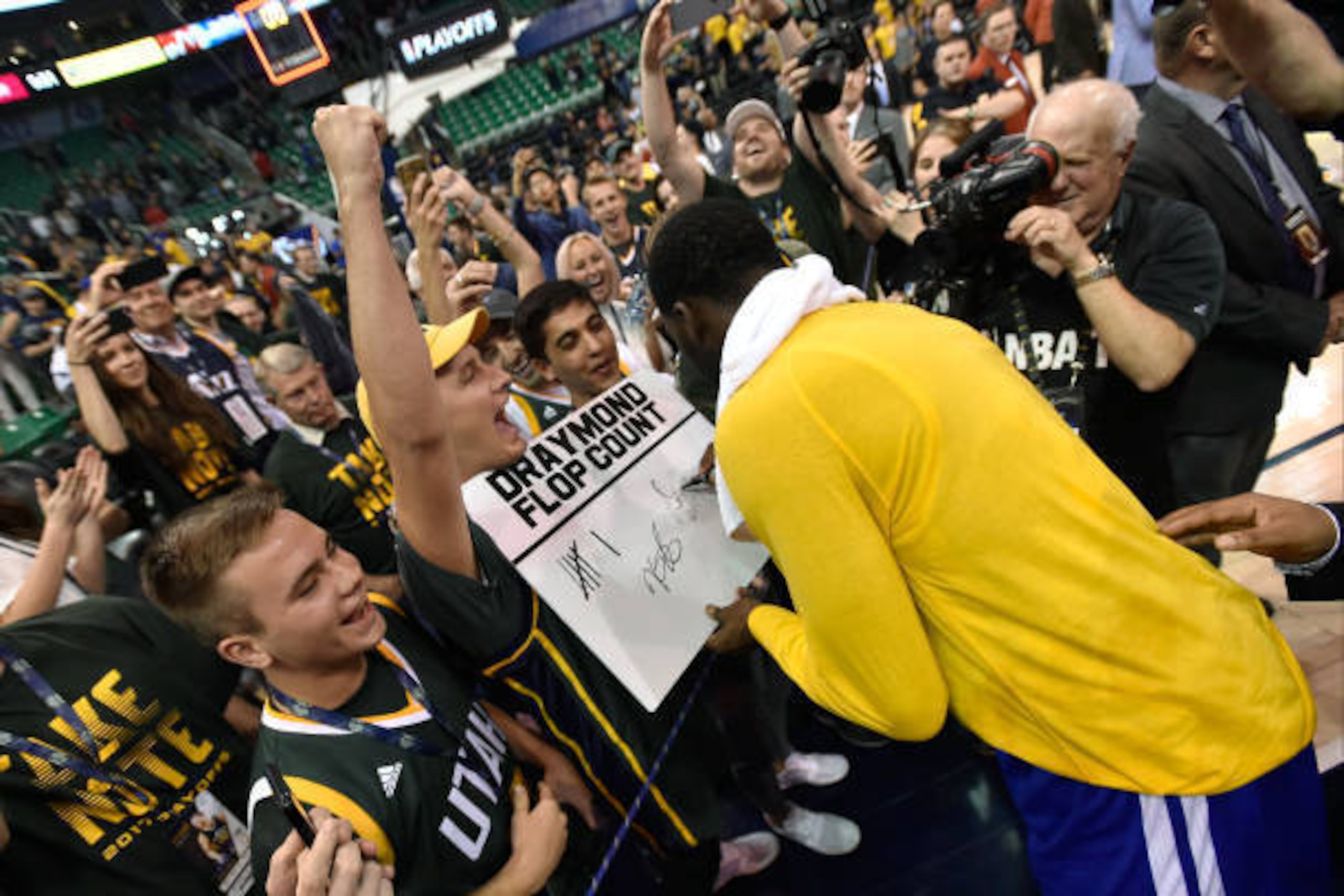 SALT LAKE CITY, UT - MAY 8: Draymond Green #23 of the Golden State Warriors signs autographs on his way off the court as the Warriors beat the Utah Jazz 121-95 in Game Four of the Western Conference Semifinals during the 2017 NBA Playoffs at Vivint Smart 